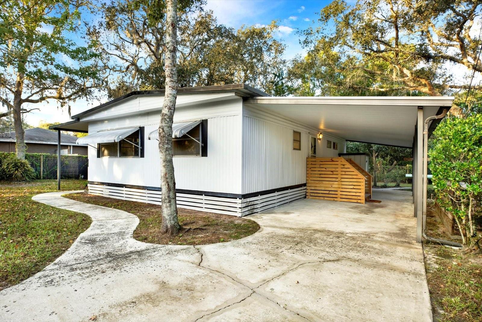 Fully Remodeled 2BR/2BA Home on Large Lot in New Port Richey! Welcome home to this completely remodeled 2-bedroom, 2-bath mobile home on a spacious 0.18-acre lot in the heart of New Port Richey! This move-in-ready home features modern upgrades throughout, including new flooring, fresh interior paint, butcher block countertops, and brand-new stainless steel appliances. Enjoy a bright and open floor plan that feels fresh and inviting—perfect for everyday living or a seasonal Florida retreat. The updated kitchen seamlessly blends style and function, offering ample counter space and storage. Step outside to your large yard, ideal for gardening, entertaining, or relaxing in the Florida sunshine. With no HOA and plenty of space for your boat, RV, or outdoor toys, this home offers true flexibility and value. Located just minutes from shopping, dining, beautiful Gulf beaches, and historic downtown New Port Richey, this home combines modern comfort and a convenient lifestyle at an affordable price.
