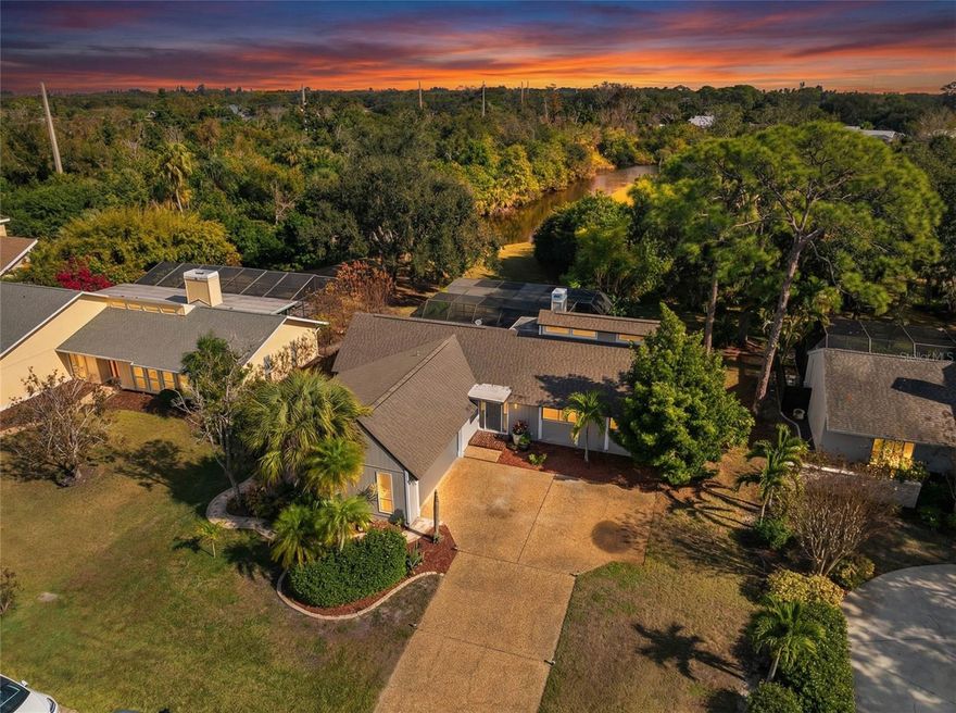 Set in the quiet and charming Beneva Woods community, this lovingly remodeled 4-bedroom, 3-bath home offers privacy, architectural character, and a peaceful connection to nature, just 15 minutes from downtown Sarasota.
The home is surrounded by mature trees and opens to a serene backyard with a screened pool and tranquil lake views beyond. Enjoy a quiet morning coffee or a relaxed evening swim; the outdoor space feels like a private retreat.
Inside, the home blends clean modern lines with warm natural textures and an eclectic, artistic sensibility. Vaulted ceilings, exposed beams, and thoughtful architectural details create a light-filled, airy feel throughout the main living spaces. The kitchen is generous and well designed, with ample cabinetry and modern finishes, overlooking the living area, perfect for everyday living and relaxed entertaining.
The primary suite is calm and inviting, with a beautifully updated spa-style bathroom featuring dual vanities and sculptural vessel sinks. Plantation shutters open to overlook the pool and greenery beyond, allowing the suite to feel quietly connected to the serene outdoor setting.
On the main level, a flexible floor plan includes additional bedrooms and a full bath that also serves conveniently as a pool bath.
A striking open staircase leads to a spacious loft on the second level with its own en-suite bath, offering an ideal space for guests, a home office, or a private retreat.
Additional features include two A/C units, two hot water heaters, a wood-burning fireplace, a large laundry room with direct access to a private dog run, and a two-car garage that includes a small air-conditioned space ideal for a workshop, hobby area, or additional storage.
This is a home that feels intentional, peaceful, and deeply cared for - a rare opportunity to enjoy privacy, architectural interest, and serenity while remaining close to Sarasota’s beaches, dining, and vibrant cultural life.