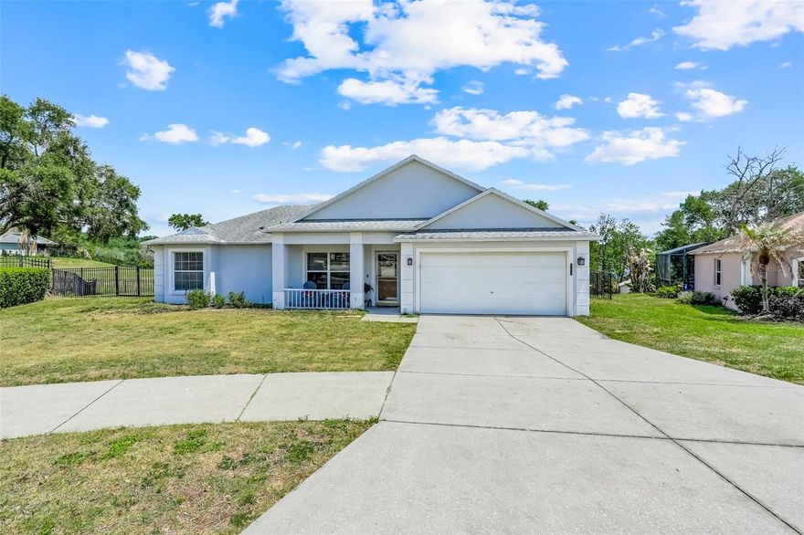 One or more photo(s) has been virtually staged. Front porch charm, backyard lake views, and a beloved neighborhood that's tucked perfectly away from the hustle and bustle, yet conveniently close to everything!  Here you will find this adorable 3 bedroom, 2 bath home, in a cul-de-sac, featuring a popular split and open floor plan, which is in the heart of one of Minneola's sought-after communities. 
Inside, you'll be greeted with high ceilings and ceramic tile throughout- no carpet, offering both style and easy maintenance.  The open living areas flow seamlessly into the kitchen, complete with granite countertops, and french doors which lead out to the covered back porch, making it ideal for everyday living and entertaining.

The split bedroom layout provides added privacy, with a comfortable primary suite and well-sized secondary bedrooms.  This home is perfect for buyers looking to add their own decorating touches and personal style.

Step outside to take your pick of which covered porch you wish to enjoy.  The backyard is fully fenced and has a beautiful view of Grassy Lake- a perfect setting for relaxing evenings or weekends.  With no rear neighbors, this backyard was meant to be enjoyed with space enough to gather around a firepit, have a swing set, and there is already a garden box in place. 

Located in Quail Valley, an established neighborhood known for its low HOA and neighborly feel, residents can enjoy sidewalk lined streets, a community playground, and a picnic area.  You will appreciate how the location is conveniently tucked away, yet just under a half mile to access HWY 27, and you're close to everyday essentials like Anytime Fitness, coffee shops, Walgreens, CVS, and a variety of dining options.   

Several updates have been done to include a new Roof (2017), HVAC (2019), new toilets, and freshly updated exterior paint. 

This is your opportunity to build equity while creating a space that fits your style!  Call me to get your private showing scheduled today-