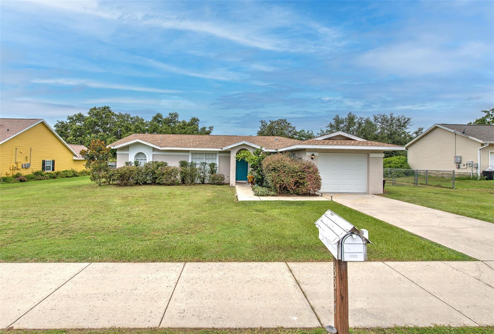 This move-in-ready 3-bedroom, 2-bath, 1-car garage home is tucked away on a quiet cul-de-sac in a convenient Dade City location. Set on 1/3 acre with a fully fenced backyard and mature fruit trees (guava, lemon, and fig), it offers both privacy and charm.
Inside, the open floor plan features easy-care laminate flooring and a spacious 19x11 family/dining room with access to a screened back porch. The renovated kitchen is a standout with quartz countertops, LG stainless steel appliances, soft-close cabinets, pendant lighting, tile flooring, and a large island with breakfast bar seating.
A cozy living room with a wood-burning fireplace and plantation shutters adds extra character. The private primary suite includes a walk-in closet and an ensuite bath with a walk-in shower. Two guest bedrooms and a full bath are located on the opposite side for added privacy.
Just minutes from downtown Dade City’s shops, restaurants, and medical centers—this home is the perfect blend of comfort and convenience!