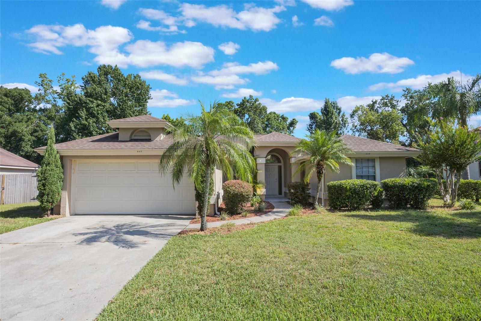 Welcome to this charming single-story home nestled in the highly desirable Wekiva area of Central Florida. This thoughtfully designed residence features an open floor plan with soaring high ceilings, skylights, and sliding glass doors that fill the living spaces with warm, natural light! The spacious great room is ideal for relaxing or entertaining, complete with a cozy wood-burning fireplace and ceiling fan to keep the space comfortable year-round. The adjacent kitchen features a large island, ample counter space, and a convenient dinette area. Designed with privacy in mind, the split floor plan offers a primary suite tucked away from the secondary bedrooms. The primary bedroom boasts a walk-in closet, direct access to the backyard via sliding doors, and bathroom with dual sinks and a large, tiled walk-in shower. Enjoy easy-care living with tile and laminate flooring throughout. The home also features a NEW AC SYSTEM 2024, offering efficiency and reliability. Step outside to the nicely manicured front yard, beautifully landscaped with shrubs and palm trees. Take advantage of all the amenities this community offers, including a community pool, playground, tennis courts and LOW HOA. Located just 5 minutes from shopping, restaurants, and with quick access to SR-429 and US 441, this home offers easy commutes to Orlando, Lake Mary, and all of Central Florida's world-class attractions. Outdoor enthusiasts will love being minutes from Wekiwa Springs State Park for hiking, kayaking, and wildlife watching. Don't miss this opportunity to live in a vibrant, well-connected community that perfectly blends comfort, convenience, and nature!