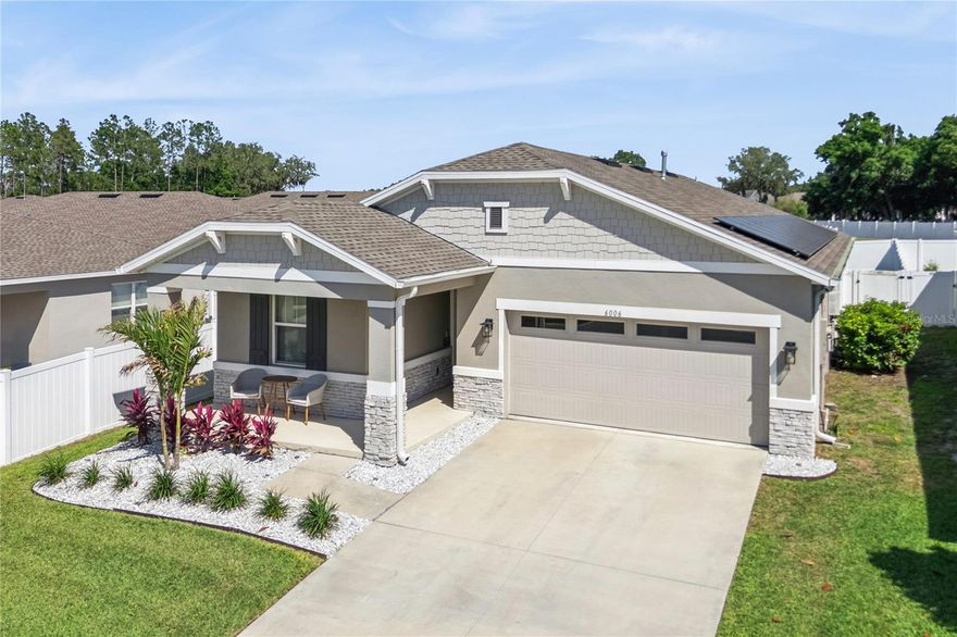 PRIVATE IN-LAW SUITE, NEW CUSTOM POOL, FULLY PAID SOLAR SYSTEM, OVER $190,000 IN UPGRADES. THIS BETTER-THAN-NEW HOME IS THE COMPLETE PACKAGE! Welcome to an exceptional and versatile 4BR, 3BA home perfectly positioned on a quiet CUL-DE-SAC, set the desirable emerging and beautiful corridor between Clermont and Leesburg. Built in 2022 and thoughtfully enhanced far beyond builder grade, this home delivers the perfect blend of luxury, efficiency, functionality, and modern Florida living. You’ll appreciate the elevated finishes throughout, including Level 6 Emser wood-look tile flooring, upgraded 5¼-inch baseboards, designer lighting and fans, and a stunning chef-inspired kitchen featuring white “Miami Vena” quartz countertops, a white porcelain farm sink, chevron subway tile backsplash, upgraded Aristokraft soft-close cabinetry, and stainless steel appliances with a gas range. The open-concept layout flows effortlessly into the spacious family room, highlighted by double glass sliders leading to the covered lanai and creating the ideal indoor-outdoor Florida living experience. The primary suite serves as a true retreat with a custom barn door entry leading into the spa-inspired bath complete with quartz counters, upgraded black fixtures, dual sinks, heavy-glass walk-in shower enclosure, and large walk-in closet. One of the most sought-after features of this home is the thoughtfully designed PRIVATE IN-LAW SUITE incorporating its own family room, bedroom, bathroom, and kitchenette, providing incredible flexibility for multigenerational living, extended guests, or private office space. Step outside into your own private backyard oasis featuring a large fully fenced 50x50 backyard a stunning custom 28ft PEBBLE-TECH POOL with sun shelf, multi-depth design, and app-controlled LED lighting. The low-maintenance AstroTurf creates a clean, resort-style feel year-round, while the covered lanai is already equipped with a dedicated gas line ready for your future outdoor kitchen. Additional premium upgrades include a fully paid $39,000 Enphase whole-house SOLAR SYSTEM designed to instantly augment electrical usage and dramatically reduce utility costs, tankless water heater, smart home security system with exterior cameras, permanent holiday lighting, and an oversized epoxy-coated garage featuring a rare 25-foot-deep bay for added storage and functionality. Located just minutes from expanding shopping, dining, medical facilities, and everyday conveniences, this home offers the perfect combination of privacy, luxury, energy efficiency, and location in one of Central Florida’s most rapidly growing areas. No waiting on new construction. No expensive upgrades left to complete. Everything has already been done for you, simply MOVE IN AND ENJOY. Hurry and schedule your private showing today. This home has been priced extremely competitively and will likely not last long.