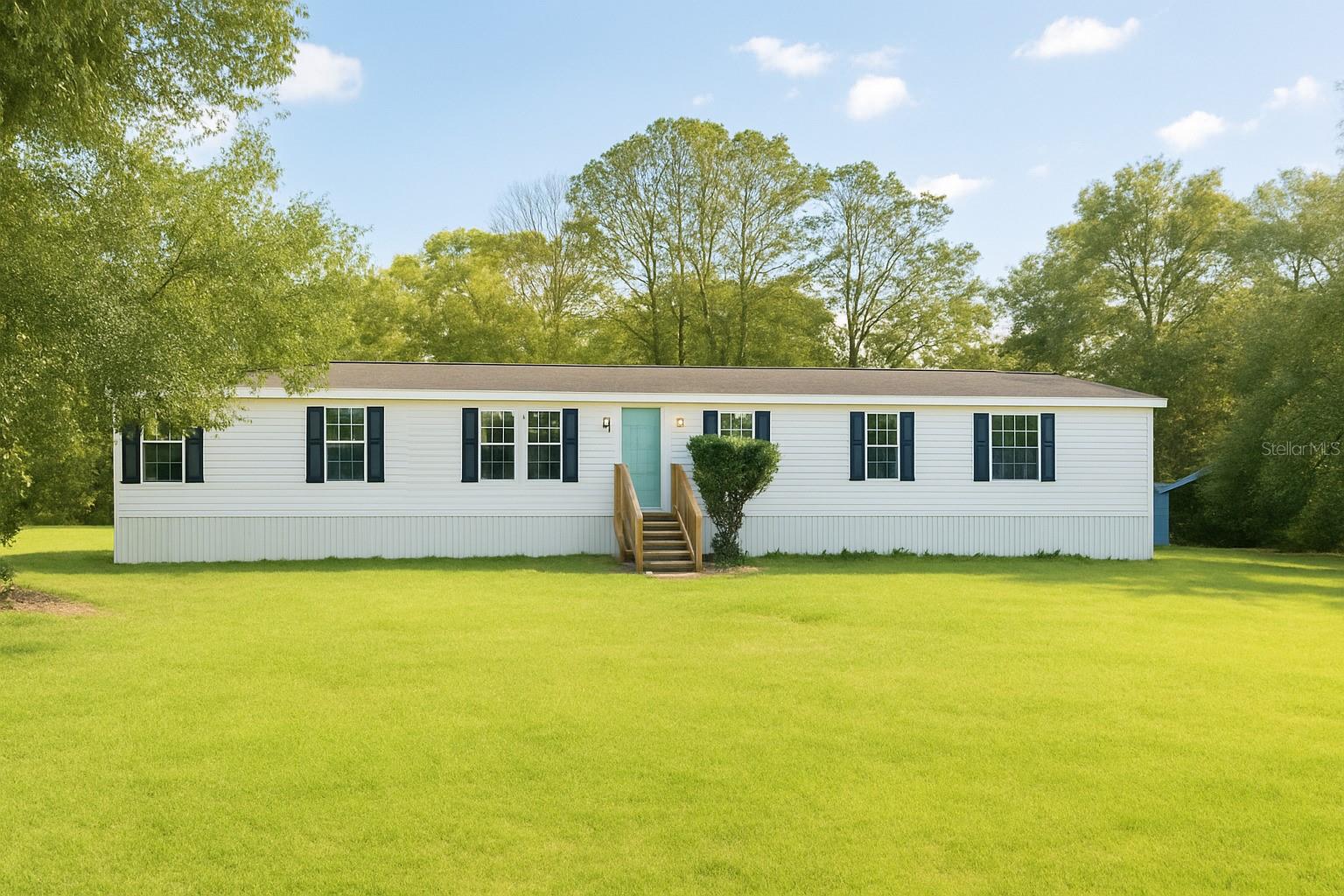 Motivated Seller. Seller will pay closing costs with full price offer. Nestled on a stunning 5-acre oasis, this 4-bedroom, 2-bathroom manufactured home offers the perfect blend of comfort and tranquility. Freshly updated in 2021 with new interior paint, flooring, AC, and appliances, this home is move-in ready and waiting for you to make it your own. But the real treasure here is the land itself. Imagine waking up to the serenity of a park-like backyard, shaded by mature trees and surrounded by woods on three sides, with bamboo providing extra privacy on the fourth. This peaceful retreat is perfect for homesteading, raising animals, or cultivating your own garden. The 600-foot driveway ensures complete seclusion, free from road noise, so you can truly enjoy the outdoors. The property is all high and dry so you can utilize all of it for your needs and desires. Whether you’re sitting on the back porch under a starry sky or gathering around a cozy fire, the potential of this property is endless. Build your dream home, explore rezoning opportunities for commercial use, or simply savor the peace and quiet. And with the beach and Disney World less than an hour away, and Downtown Mount Dora and the 429 extension just a short drive, you’re never far from everything Central Florida has to offer. This is more than just a home; it’s an opportunity to create the lifestyle you’ve always dreamed of. Don't miss out on this unique chance to own a piece of paradise.