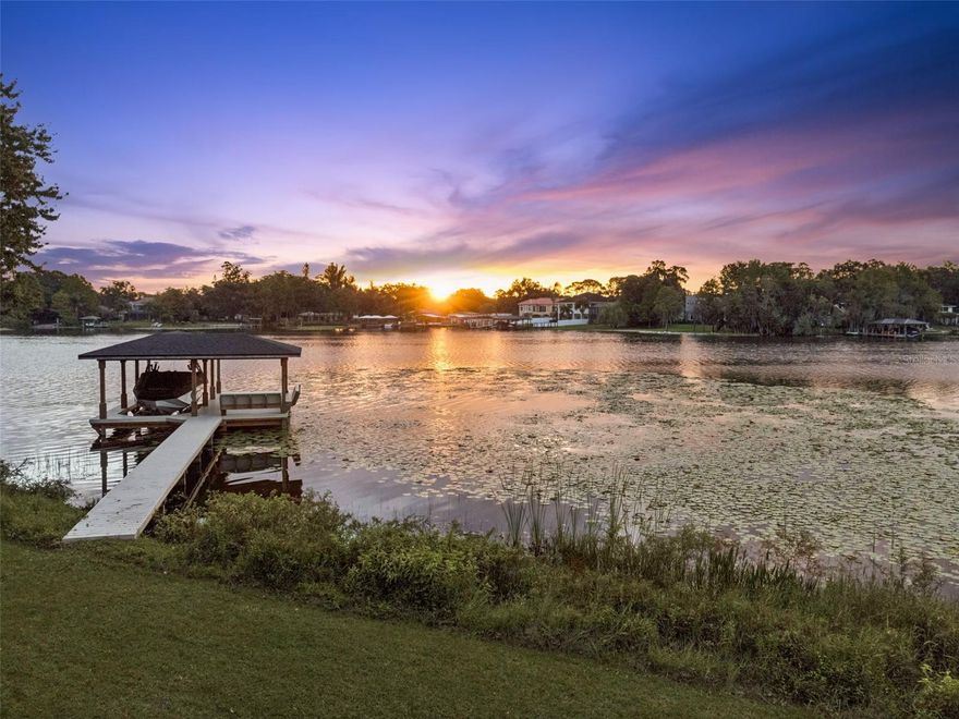 Boat House with lift | Gourmet Kitchen | Recently Updated 5-Bedroom Lakefront Retreat on Skiable Lake.  Presenting 5619 Padgett Circle, a beautifully updated 5-bedroom, 3-bath lakefront home, situated along the shore of the 294-acre, skiable Lake Jessimine. This exceptional .80 acre property offers breathtaking water views and a true Florida lifestyle. With a new roof (2025), freshly painted interior and exterior, and a new covered dock with boat lift—perfect for fishing, boating, and water skiing right from your backyard.  Inside, discover an updated gourmet kitchen with premium appliances, quartz countertops, and elegant finishes that open to bright, inviting living spaces with custom flooring throughout. The open layout is ideal for entertaining, and the large, screened-in lanai is the perfect spot for morning coffee while soaking in the spectacular sunrise view of the water. Enjoy the tranquility of your private lakefront setting with direct water access. With no HOA and no gated restrictions, you’ll have the freedom to truly make this home your own. Centrally located near Orlando's premier medical area, including Winnie and Arnold Palmer hospitals, and Orlando Health medical center. It is also convenient to The Florida Mall, Millenia Mall, Downtown Orlando, and Orlando’s world-famous theme parks. This lakefront gem combines style and serenity — offering the perfect blend of space, convenience, and the laid-back Florida lakefront lifestyle.