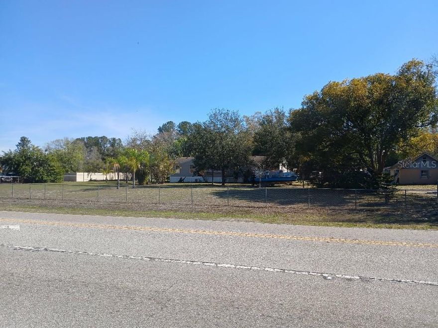 1.22-acre corner parcel with Gunn Highway frontage located approximately 0.37 miles south of SR 54 in Odessa. Positioned along a transitional corridor with nearby C2 commercial zoning and established commercial development. Excellent visibility and access at signalized intersection. Public water connected with Septic system.

Property includes two mobile homes, a detached block workshop/garage and carports. All structures are included in the sale and convey as part of the real property. Property is being marketed primarily for land value. 

Buyer to verify all zoning, land use, and development potential with Pasco County. Please do not disturb occupants.