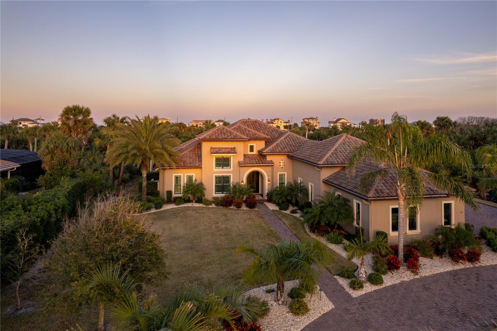 Welcome to The Marbella, an extraordinary and rare home designed by Arthur Rutenberg Homes, one of only two built in the entire state of Florida. Located in the prestigious waterfront community of Island Estates in Hammock Dunes, this property is the ultimate in luxury living. Positioned on a lush 1.5-acre lot with breathtaking views of wetlands and the serene canal, this home offers unmatched privacy and a connection to nature.
The custom 4-car garage features two 8-foot by 18-foot heavy-duty garage doors, along with ample storage space and a Florida basement above, offering additional room for storage or future projects. The home is fully wired for a generator, ensuring peace of mind during power outages, and boasts whole-house gutters to keep the property in pristine condition.
The great room, club room, and office feature a unique floor plan, providing a balance of open spaces for entertaining and quiet retreats for relaxation. The 10-foot sliding glass doors, including two 90-degree doors in the club and dining rooms, bring the outdoors in, offering seamless flow from the interior to the stunning outdoor spaces. Custom metal front doors elevate the entry, making a bold statement from the moment you arrive.
This home is designed with comfort and luxury in mind, with en-suite baths in all bedrooms and walk-in closets for every occupant. The master bath is a true spa retreat, featuring a marble finish with a four-shower-head system, designed for the ultimate relaxation experience. The built-in storage in the master closets is complemented by a marble-topped island in one closet, offering both practicality and elegance.
Enjoy the culinary experience of a gourmet kitchen equipped with GE Monogram appliances, including three ovens and a six-burner gas stove. The hidden pantry offers extra refrigeration and a coffee station, perfect for culinary enthusiasts. The home also boasts a wet bar in the club room with a beverage chiller, a dry bar with a wine chiller in the dining room, and a 145-bottle wine room off the dining area, ideal for the most discerning connoisseur.
For comfort and efficiency, the home is equipped with two HVAC systems and a tankless gas water heater with an instant-on system, ensuring year-round comfort while reducing energy consumption. There are three home pantries/storage rooms throughout the house, keeping your living spaces organized and functional.
Outdoor living is nothing short of spectacular, with a screened-in pool, lanai, and cabana. Relax by the gas fireplace while enjoying the outdoor kitchen complete with a gas grill, sink, trash, and beverage chiller. The travertine flooring throughout the lanai adds a touch of luxury to your outdoor oasis. Whether you're swimming in the saltwater pool with fountains and a sun shelf or relaxing in the hot tub with both gas and electric heaters, the outdoor amenities are perfect for both relaxation and entertainment.
Outside, you’ll find a beautifully fenced yard complemented by a circular driveway with pavers.
Hammock Dunes Club membership is available but not required. Recognized as one of the world’s top private clubs, Hammock Dunes features two Audubon-certified golf courses, an oceanfront clubhouse, pool, fitness center, croquet, social activities, and exceptional dining options. Enjoy the charm of small-town living with pristine beaches, all while being just an hour away from both Jacksonville and Orlando.