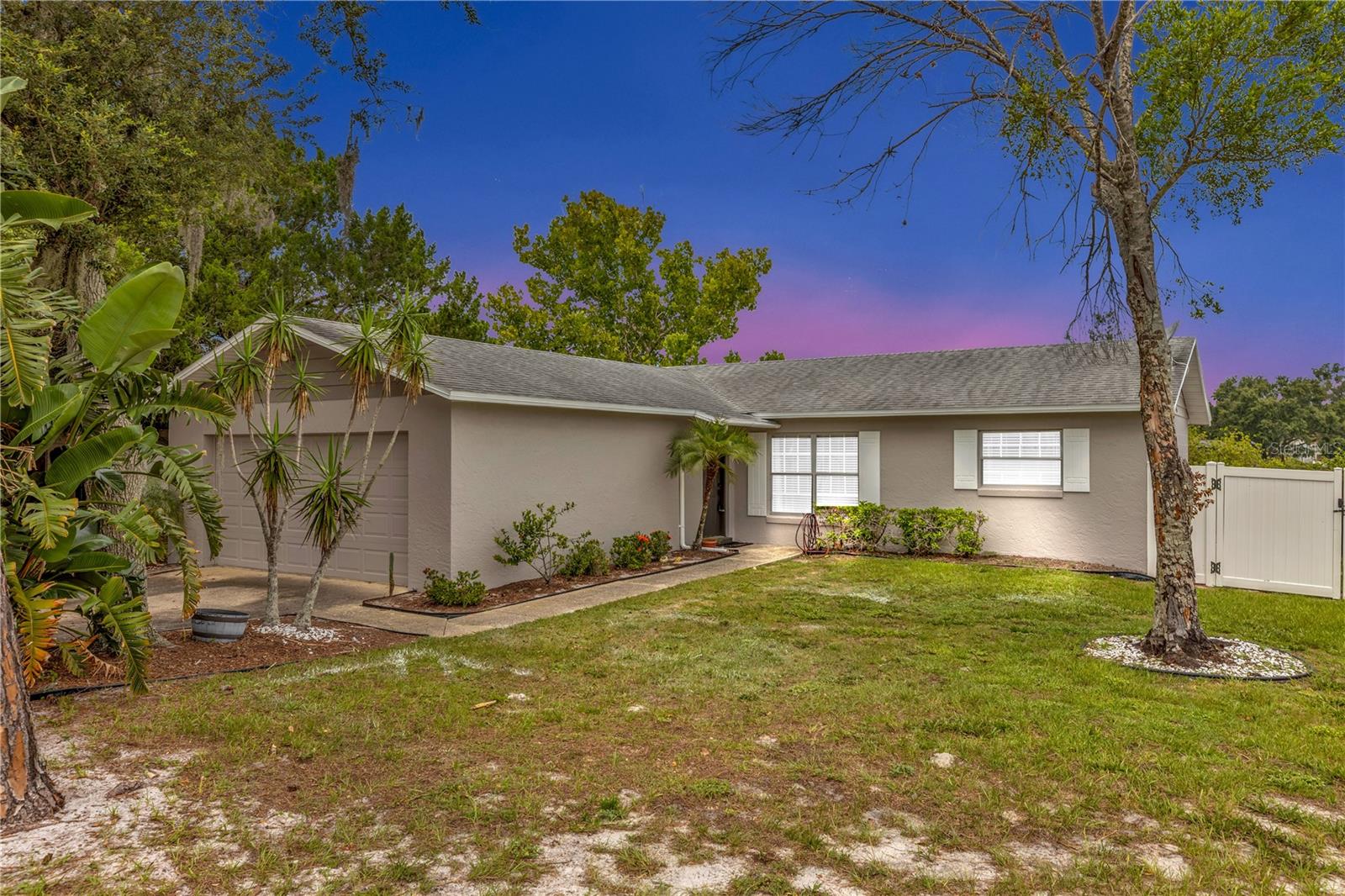 COMPLETELY RENOVATED LAKEFRONT HOME on an oversized lot (.46 acres)!! Step into modern elegance with this fully renovated 3-bedroom, 2-bathroom home offering serene lakefront views and stylish upgrades throughout. From the moment you arrive, you'll notice the freshly painted exterior and inviting curb appeal. Inside, the home features BRAND NEW luxury vinyl plank flooring, fresh interior paint (and fresh exterior paint!), and contemporary fixtures that complement the open and airy layout. The kitchen has been updated with modern hardware and stainless steel appliances, giving it a clean and contemporary feel that blends seamlessly with the rest of the home. Both bathrooms have been fully remodeled, featuring new vanities, toilets, and tasteful finishes. Whether you’re sipping your morning coffee with a lake view or entertaining guests in the open living space, this home offers comfort, convenience, and a move-in-ready lifestyle in a picturesque setting. You do not want to miss this opportunity. Schedule your private tour today! This home may be under audio and visual surveillance.