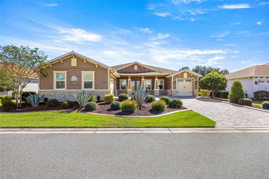 GOLF COURSE VIEW! WHOLE HOUSE GENERATOR! SOLAR TUBES! ENCLOSED LANAI! SCREENED PATIO! Welcome to this stunning Aberdeen model home, perfectly positioned on the golf course with beautiful views. From the moment you arrive, you’ll be impressed by the home’s curb appeal—stone-accented exterior, paver driveway and walkway, and a charming covered front porch. The grand entry opens to an inviting foyer featuring an accent wall, tray ceiling with crown molding, and a sparkling chandelier.  Inside, the open layout is ideal for entertaining. The spacious great room showcases a tray ceiling, recessed lighting, and a beautiful accent wall, while the nearby office with sliding doors offers a quiet space to work or relax. The gourmet kitchen is a chef’s dream—complete with a large island, granite countertops, custom cabinetry with crown molding, and a full GE Café appliance package including a six-burner gas range, wall oven, and French-door refrigerator. Extra details like soft-close drawers, spice racks, under-cabinet lighting, farm style sink, and solar tubes make this space both stylish and functional. A walk-in pantry with custom shelving and a bright dining area add convenience and comfort.  The primary suite offers a peaceful retreat with a tray ceiling, recessed lighting, large window, and custom-built walk-in closets. The en-suite bath features double vanities, an upgraded light/fan combo, and a luxurious stone walk-in shower with pebble flooring. The second suite includes a Murphy bed, custom closet, and tiled walk-in shower, while the third bedroom and guest bath are perfect for visitors. Enjoy Florida living year-round in the extended enclosed Florida room, featuring hurricane-rated windows, dual Mitsubishi AC units, and separate thermostats. Step outside to a screened porch that leads to an expansive stone patio—ideal for outdoor dining, relaxing, or simply soaking in the gorgeous golf course views. The yard includes beautiful landscaping, a low stone wall, and garden beds for easy care. Additional highlights include a large laundry room with cabinets, sink, and folding counter, plus a mudroom with built-in seating and desk. The two-car garage is complete with painted floors, while the separate golf cart garage is cooled from main AC and has an insulated door.  Upgrades throughout the home include crown molding, 6” baseboards, upgraded lighting and fans, wood window cornices, soft-close cabinetry, gutters, a whole-house generator, remote-controlled shades, and a water filtration system. Located in Candler Hills West, Ocala’s premier 55+ golf course community, residents enjoy access to the pool, fitness center, restaurant, a dog park, and more. Close to shopping, restaurants, medical offices, and short distance to the World Equestrian Center! Don’t miss your chance to own this exceptional home where elegance, comfort, and lifestyle come together perfectly.