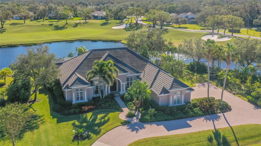 This exquisite custom Arthur Rutenberg home is poised on one of the most majestic sites in all of Laurel Oak Estates. It presents a unique opportunity to experience life in a beautifully enhanced home while basking in the sweeping water views and the long rolling fairway and green of Hole 16 of the Player course. The gorgeous curb appeal of this corner homesite is matched by privacy on all sides with lush tropical landscaping and 370 feet of calming lake frontage. The 14-foot ceilings are complemented by an abundance of windows and glass doors highlighting the views and flooding the home in beautiful natural sunlight.
No expense was spared transforming nearly every corner of this house to a designer standard with superior finishes and fixtures. Four bedrooms, four full bathrooms, an office/den, kitchen/great room, living room, dining room, double sided wet bar and buffet and a lanai with pool, spa and Summer Kitchen.
Cooking and gathering in the kitchen will be a joy with restructured islands, a 5 burner Thermador gas range, double Thermador ovens, Subzero refrigerator, new Elite cabinetry, Waterworks hand-made porcelain tile backsplash, hand-blown Italian pendant lights and cabinet lighting. Rohl faucets added throughout the entire home with Hubbardton Forge light fixtures, including multiple Pure Edge style.
Delight in the Owner’s Suite, a genuine spacious retreat for relaxing and unwinding. There is a place for everything in the thoughtfully designed European fashion custom closets. Escape to the reconstructed spa-worthy bathroom with custom cabinetry and lights, a large walk-in shower and one-of-a-kind free standing tub and tile surround.
Take comfort in knowing the first-rate roof is 4 years old and warranty conveys. The upgraded variable speed AC units are newer as well. A 4 part water purification system and reverse osmosis ensures the water quality. Rinnai gas water heater. The mechanics are exemplary. Other improvements and features include Central vacuum, brand new Polyaspartic Flake garage floor, new screens and new awning on lanai, newer alarm system and keypads, freshly painted exterior and lanai surface, a redesigned laundry room and brand-new washer, new wool carpet in all guest rooms. Newer granite, Elite cabinetry and, enhanced lighting in wet bar/buffet. Summer kitchen with newer grill and granite with UV protection.
You will love this captivating home and the remarkable and impeccable improvements made with the utmost attention to detail. Entertain with ease or simply revel in the comfort of your surroundings knowing you found an extraordinary residence to call home.
Laurel Oak is comprised of 813 fenced acres and 405 homes. Miles of double wide 8-foot sidewalks meander through the community. 24/7 guard-gated entry, well managed and maintained. Laurel Oak Country Club memberships are optional. The Laurel Oak lifestyle is second to none.