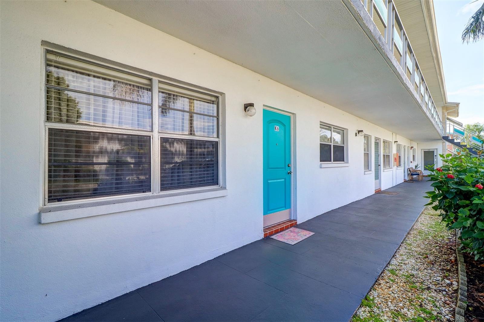 Must see this lovely first floor condo - an inside corner unit. Covered carport, K6 parking is just steps from back door of unit. This beautifully well cared for immaculate condo has 2 spacious bedrooms, one bath plus an upgraded Florida room (perfect room for office or guests). Florida room has newer windows and a storage closet. Newer kitchen appliances. Some furniture is available. Condo has 870 heated square feet plus the 7' x 23' air conditioned Florida room (approximately 1031 total square feet). Monthly maintenance fee is $556 and includes gas for central heat and cooking, water, sewer, trash, cable, internet, laundry facility, extra storage space, building insurance, recreational facilities, heated pool, shuffleboard and many more activities and amenities. Newer wood laminate floors, carpeted bedrooms and tile floor in bathroom. New roof was replaced in 2024. Town Apts is a 55+ community. No rentals allowed. Only emotional support animals allowed with appropriate documentation from veterinarian. Town Apts. complex is a desirable well maintained community. Located conveniently nearby shopping, restaurants, the city bus line and minutes to airports, the interstate highway and downtown St Petersburg. Located in flood zone "X" (currently flood insurance is not required by lenders in "X" zones). Town Apts Condo complex is affordable living in a very desirable area.