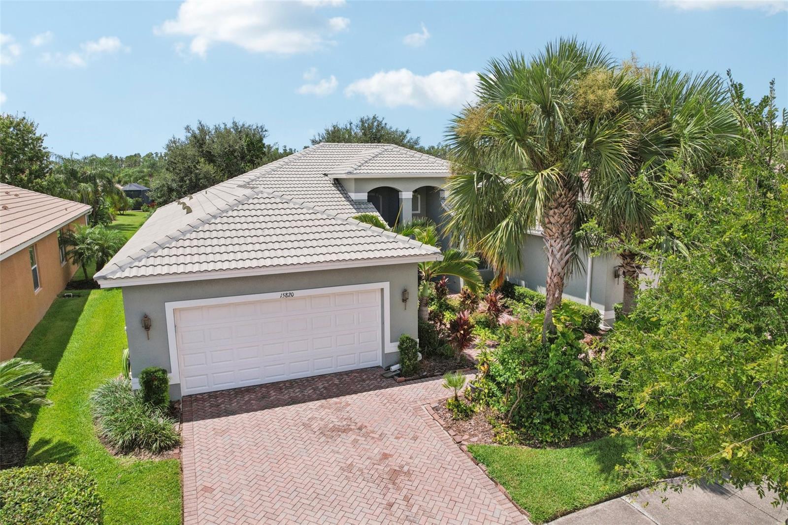 Welcome to your dream home in the sought-after Valencia Lakes community! This beautifully maintained waterfront villa features 2 bedrooms, 2 bathrooms, plus a versatile den that can serve as a 3rd bedroom or office. You'll be greeted by a designer paved driveway and walkway, surrounded by lush, professionally landscaped plants, creating a warm and inviting curb appeal.
Inside, enjoy a bright, open-concept layout with soaring ceilings and seamless flow between the living, dining, and kitchen areas. The spacious kitchen offers stainless steel appliances, an eat-at bar, abundant cabinet and pantry space, and a cozy dinette nook with a convenient laundry closet.
Take in stunning water views through large sliding glass doors leading to the screened-in lanai—perfect for relaxing or entertaining. The generously sized primary suite includes a spa-like en suite bathroom with double sinks, stand up shower and a private water closet. Plus a large walk in closet off the bathroom with plenty of room for all your needs.
Valencia Lakes is a premier 55+ active adult golf cart community, offering a vibrant lifestyle surrounded by resort-style amenities. The community features a stunning 40-acre waterfront outdoor recreation area with a heated resort pool, lap and resistance pools. Residents enjoy access to a 40,000 sq. ft. clubhouse, Har-Tru tennis courts, a state-of-the-art fitness center, half-court basketball, pickleball and bocce courts, a dog park, baseball park, and a community garden.
For outdoor enthusiasts, there’s over 100 acres of preserved natural areas, perfect for enjoying peaceful water views, birdwatching, and local wildlife. Additional conveniences include RV and boat storage and hundreds of clubs and activities to suit every interest.
Valencia Lakes is known for its warm, welcoming neighbors and strong sense of community — the perfect place to enjoy an active and fulfilling lifestyle.