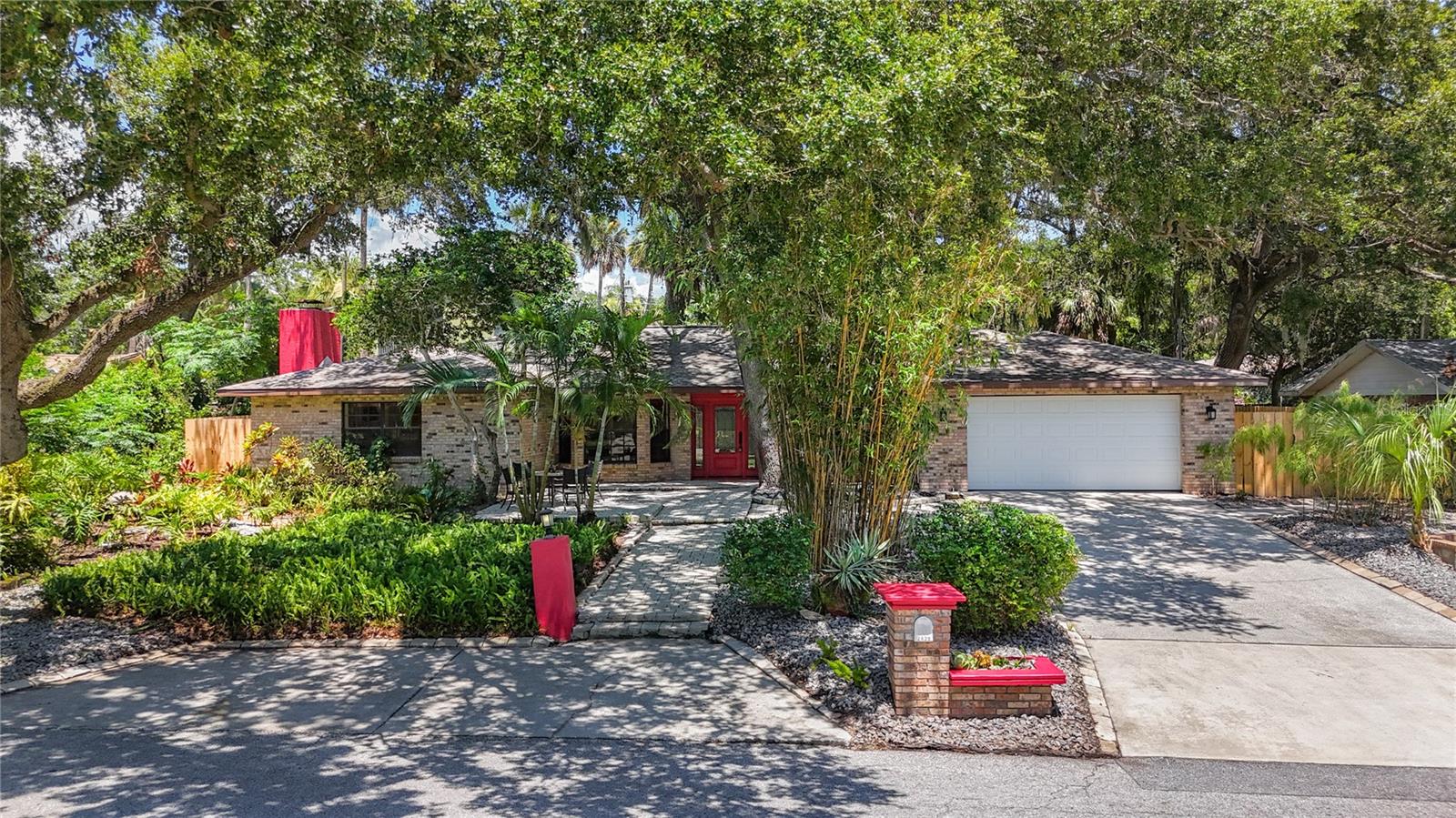 Welcome to your enchanting private retreat nestled in the heart of Safety Harbor! This stunning home is situated on an expansive, beautifully landscaped double lot adorned with towering, majestic oak trees that create a serene sanctuary. With 3 spacious bedrooms, 2 luxurious baths, and a versatile bonus room, this property perfectly blends charm and functionality, offering a true embodiment of the idyllic Florida lifestyle. Set in Flood Zone X, high and dry at approx. 36 ft above sea level, non-evacuation zone. This great home is just a leisurely stroll away from the scenic Philippe Park and the shimmering waters of Tampa Bay, making the location as exceptional as the home itself. Imagine sipping your morning coffee on the sprawling front porch, a perfect spot for catching up with neighbors or simply basking in the tranquil, small-town atmosphere of this welcoming and walkable community. As you step through the custom front door, you’re greeted by a charming foyer that flows into inviting formal living and dining rooms. As you venture further, you’ll discover the gourmet kitchen—truly the heart of this home—boasting exquisite granite countertops, rich wood cabinetry, and top-of-the-line stainless appliances including a stylish beverage cooler, a casual dining space, and a breakfast bar. The kitchen dazzles with a custom tile backsplash and features a striking accent wall, setting the tone for gatherings and culinary creativity. The kitchen seamlessly transitions into the vaulted family room, where a cozy, brick-faced, wood-burning fireplace beckons you to unwind, while French doors open to reveal an enchanting outdoor oasis. Retreat to the primary suite, a true sanctuary in itself, featuring its own inviting fireplace and a spa-like en-suite bath. Here, you’ll indulge in dual vanities, meticulously crafted custom cabinetry, a spacious walk-in shower, and a free-standing jetted tub with a wall of windows and double French doors allowing the outside and inside to flow seamlessly, elevating your daily routine into a luxurious experience. The secondary bedrooms are spacious and have plenty of storage. The third bedroom has barn doors that open to the versatile bonus room, perfect for an office, playroom, gym, or 4th bedroom. This home also offers a thoughtfully designed utility room, complete with a pantry, washer/dryer, and an exterior door leading to a secure dog run, perfect for your furry family members. Step outside into your private backyard oasis—an enchanting space that boasts a screen-enclosed pool with a raised spillover spa, surrounded by an expansive composite deck and stylish tiled social areas. There’s no shortage of space here for outdoor dining, relaxation, and entertaining family and friends. Located in a tranquil neighborhood with a strong sense of community and served by highly rated schools, this family-friendly home is just moments away from Safety Harbor’s vibrant Main Street. Experience the pulse of the community with its lively festivals, monthly gatherings, delightful art walks, a variety of restaurants, charming bars, unique shops, and a flourishing local arts scene. Come take a look…You’ll like what you see!