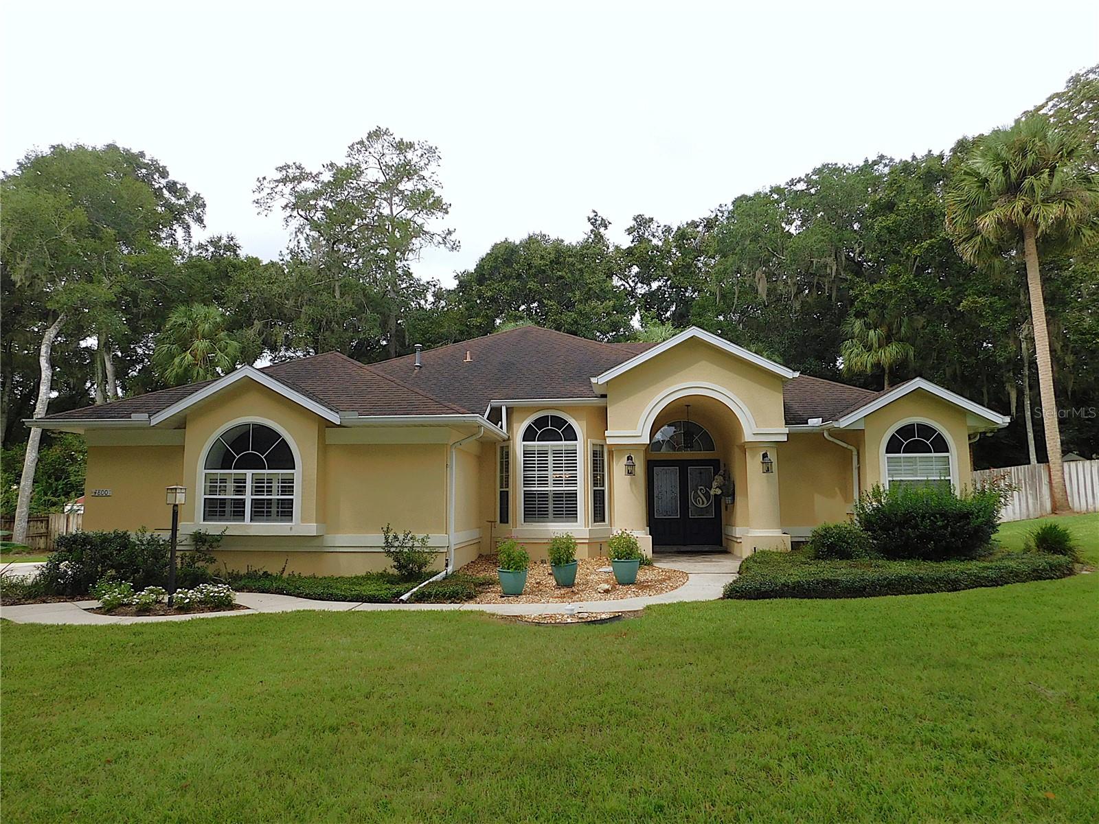 LOCATION!!! LOCATION!!! 3BR/2BA/2GA POOL home in desirable SW community with .71 fenced acre lot.. Located in the heart of Ocala, this spacious home offers a fabulous floor plan with over 2100 sf living area, high ceilings, sweeping views of the backyard, formal living room plus separate family room w/gas fireplace & built-ins, formal dining room w/built-ins, eat-in kitchen w/walls of windows overlooking the screened pool, primary bedroom suite with double walk-in closets & remodeled bath with jetted tub & gorgeous shower, guest BR features space-saving Murphy bed, guest BR #3 located next to remodeled guest bathroom, plus a dreamy laundry room.. Enjoy the beautiful Florida weather in the screened & heated pool with relaxing waterfall, under the covered lanai sipping coffee or entertaining guests with a convenient summer kitchen nearby or lounging on the pool deck.. Pool access from the living, family room, primary suite and guest full bath for easy access.. Roof replaced in 2012, inground pool resurfaced in 2014, water heater in 2018, ac/heat in 2019, well pump in 2024, & gas generator in 2019. Conveniently located near every convenience including shopping, dining, medical facilities & schools.. If you are looking for a spacious pool home, DON'T MISS THIS ONE!!!