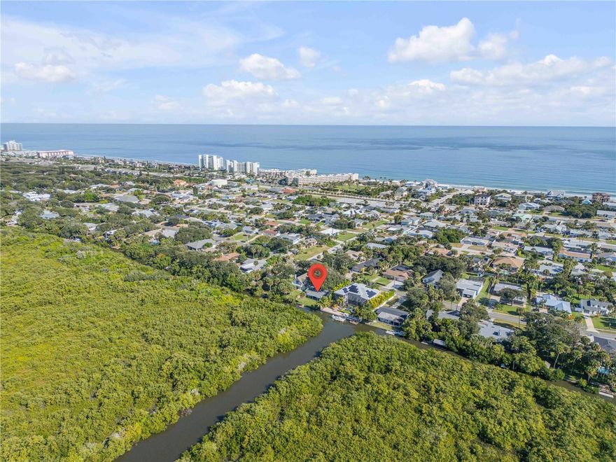 Built in 2019 by Brent Walters, this custom-crafted and impeccably maintained 4-bedroom, 2.5-bath beachside pool home offers a blend of refined design, privacy, and coastal charm, just steps to the ocean. Filled with natural light, this residence lives like a private retreat. The open-concept main living area flows effortlessly, featuring a chef-inspired kitchen with solid surface countertops, stainless steel appliances, a generous breakfast island, and stylish finishes are perfect for both entertaining and everyday living. Spacious living areas provide plenty of room to gather with family and friends. The spacious primary suite has a private balcony to enjoy the coastal breezes. The ensuite bath is thoughtfully designed with a freestanding soaking tub, a large walk-in shower with floor-to-ceiling tile, and elegant finishes throughout. The additional bedrooms share a well-appointed Jack-and-Jill bathroom. The third-floor landing offers a versatile flex space ideal as a 4th bedroom for a home office, reading nook, or creative retreat. Step outside to your own private oasis, complete with a sparkling saltwater pool and outdoor shower, perfect for relaxing after a day at the beach. Additional highlights include a 2-car garage, a whole-home Generac Generator, and well-designed indoor-outdoor living spaces. Located in the desirable Silver Sands beachside community of New Smyrna Beach, this home offers convenient beach access and a laid-back coastal lifestyle. Whether you're seeking a primary residence, vacation home, or investment opportunity, this property delivers exceptional comfort, location, and appeal. Schedule your private showing today.