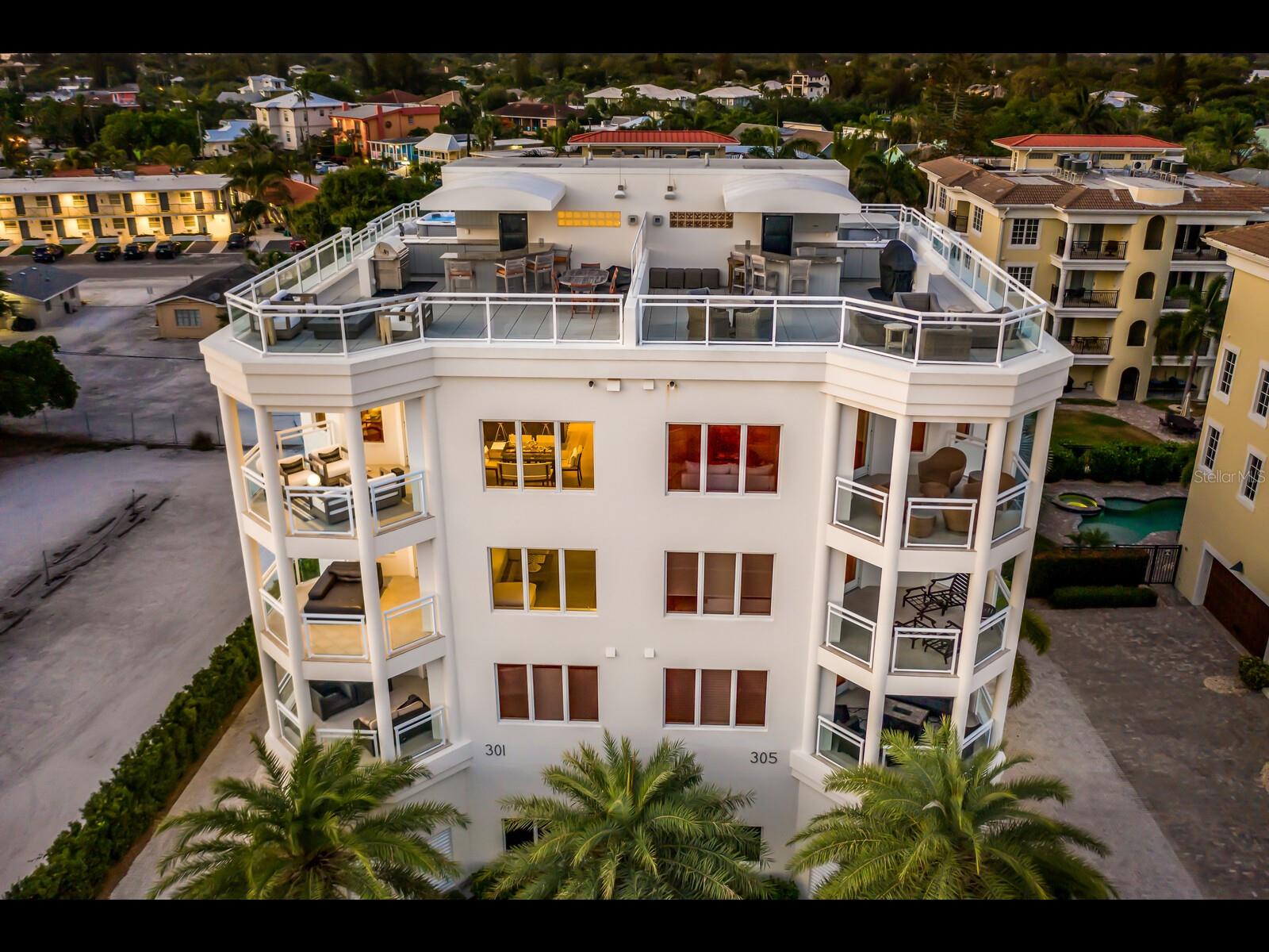 Experience the ultimate in beachfront luxury living with this exquisite Penthouse Villa, located just steps away from the pristine Siesta Key beach. This stunning property offers panoramic views of the Gulf, and a 2-minute walk into the vibrant dining and shopping district of Siesta Village.
Nestled in a boutique luxury building of only 4 total units, this hybrid living offers the best of both worlds - the privacy of your own home with the benefits of a lock-and-leave condo. Indulge in the Florida lifestyle and watch the sunset over azure Gulf waters from your own private rooftop terrace. Unwind in the hot tub, kick back by the fire pit and entertain behind a full bar and kitchen.
The interior is equally impressive, with multi-level living featuring two guest quarters, a formal living room with wet bar and private terrace. An epic master suite is serviced by a private elevator to each level, elevating living to the next level. After soaking up the sun on the sand, cool off in the pool before gathering in the chef’s kitchen or on an additional terrace adjacent to it with family or guests before hitting the Village for the evening.
This rare gem on Siesta Key is truly an opportunity to experience the youthful and vibrant lifestyle of the area from a bird’s eye view. With virtual and in-person showings available, don't miss your chance to live the good life in this exceptional Penthouse Villa.
