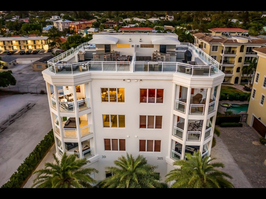 Experience the ultimate in beachfront luxury living with this exquisite Penthouse Villa, located just steps away from the pristine Siesta Key beach. This stunning property offers panoramic views of the Gulf, and a 2-minute walk into the vibrant dining and shopping district of Siesta Village.

Nestled in a boutique luxury building of only 4 total units, this hybrid living offers the best of both worlds - the privacy of your own home with the benefits of a lock-and-leave condo. Indulge in the Florida lifestyle and watch the sunset over azure Gulf waters from your own private rooftop terrace. Unwind in the hot tub, kick back by the fire pit and entertain behind a full bar and kitchen.

The interior is equally impressive, with multi-level living featuring two guest quarters, a formal living room with wet bar and private terrace. An epic master suite is serviced by a private elevator to each level, elevating living to the next level. After soaking up the sun on the sand, cool off in the pool before gathering in the chef’s kitchen or on an additional terrace adjacent to it with family or guests before hitting the Village for the evening.

This rare gem on Siesta Key is truly an opportunity to experience the youthful and vibrant lifestyle of the area from a bird’s eye view. With virtual and in-person showings available, don't miss your chance to live the good life in this exceptional Penthouse Villa.