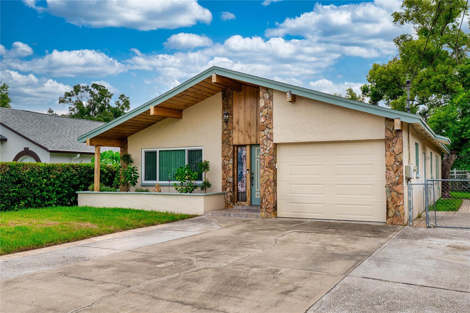 Welcome to this charming 3-bedroom, 2-bath home perfectly situated near Kirby Creek in the heart of Tampa! Step inside to a welcoming living room featuring a cozy fireplace with a beautiful stone hearth—ideal for relaxing evenings at home. The spacious kitchen offers ample room for a dining table and chairs, making it the perfect space for casual meals or entertaining guests. The primary bedroom includes a private ensuite bath, while two additional generously sized bedrooms share a second full bath located off the hallway. Outside, you'll find a well-maintained backyard complete with a handy storage shed for lawn tools or hobbies. The 1-car garage is complemented by a wide driveway and additional parking pad. Just minutes from Dale Mabry Highway and the Veterans Expressway, this convenient location puts you close to everything Tampa has to offer. Schedule your showing today and discover the potential of this centrally located gem!