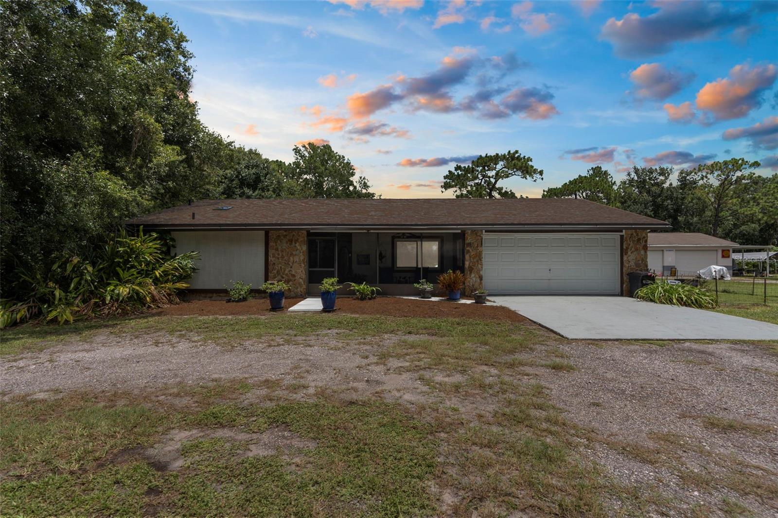 Stunning 5-Bedroom POOL Home on TWO ACRES– Move-In Ready with Dual Master Suites! Welcome to your private oasis on 2 beautifully landscaped acres, just minutes from the Veterans Expressway, Cheval, Heritage Harbor, Villa Rosa, shopping, dining, and outlet malls – yet tucked away in a quiet, peaceful neighborhood that feels like the country. NO HOA, NO CDD, NO FLOOD ZONE! This move-in ready estate home features 5 bedrooms, 2 bathrooms, and a flexible layout that can easily accommodate a 6th bedroom, in-law suite, or dual master setup. Step into a FRESHLY PAINTED interior through the screened-in front porch, the perfect spot to relax and enjoy the sounds of nature! As you enter, the home opens to a thoughtfully designed SPLIT FLOOR PLAN with recessed lighting throughout and abundant living space. The master suite wing is a retreat of its own—featuring a home office, private home gym with mirrored walls and lighting, spacious bedroom with sliding glass doors to the pool, dual closets, and a luxury bath with walk-in shower, extra-large garden tub, separate water closet, and a vessel bowl sink vanity with generous storage. Entertain in the OVERSIZED formal dining room with a storage closet, unwind in the EXPANSIVE living room, or enjoy a book in the parlor through elegant French doors. At the heart of the home is a chef’s dream kitchen featuring: Solid wood shaker cabinets with granite countertops, Movable island, Double oven AND 4-burner glass cooktop, AND an amazing stove with current set up as two burners and hot plate, however there are additional burners, steamer, deep fryer, and grill inserts to create a variety of options!! Pot filler plumbed over the cooktop and stove, Ceiling exhaust fans and 100 CFM vent fans above each range, New dishwasher, Under-cabinet lighting, Built-in microwave with convection and infrared cooking, Walk-in pantry, Pass-through window and door to pool area, and Extra kitchen A/C vent for added comfort! Two spacious guest bedrooms are large enough for king-size beds and feature walk-in closets. One bedroom has an en-suite bath with walk-in shower, vessel sink, and direct hall and pool access—great for guests or as a second master suite. The screen-enclosed POOL is your own private paradise with new RESURFACING(2021), NEW PUMP(2025), and a 6-foot depth. The hot tub boasts a NEW HEATER ELEMENT AND PUMP. Multiple access points include doors from the kitchen, pool bath, and master suite out to the pool. Additional features: ROOF (2021), NEW Windows Replaced (2021), AC (2008) serviced yearly, updated electrical panels, 3 storage sheds convey, Fully fenced backyard with separate dog run and multiple dog doors leading out, Washer/dryer (<1 year old) convey, 2.5-car garage with laundry area, Hot water heater timer system and WATER SOFTENER installed! The Furniture is available separately. Enjoy a beautifully maintained yard with towering pine and oak trees, landscaped bases, and regular visits from local deer in the mornings and afternoons. This is the RARE property that offers comfort, functionality, and flexibility—great for multi-generational living, entertaining, or just enjoying the peaceful surroundings. Ideally situated between Lutz Lake Fern Road and SR-54, with quick access to the Veteran’s Expressway, shopping, and dining, this property offers the best of both worlds. THere is a walk through video attached, click virtual tour button.