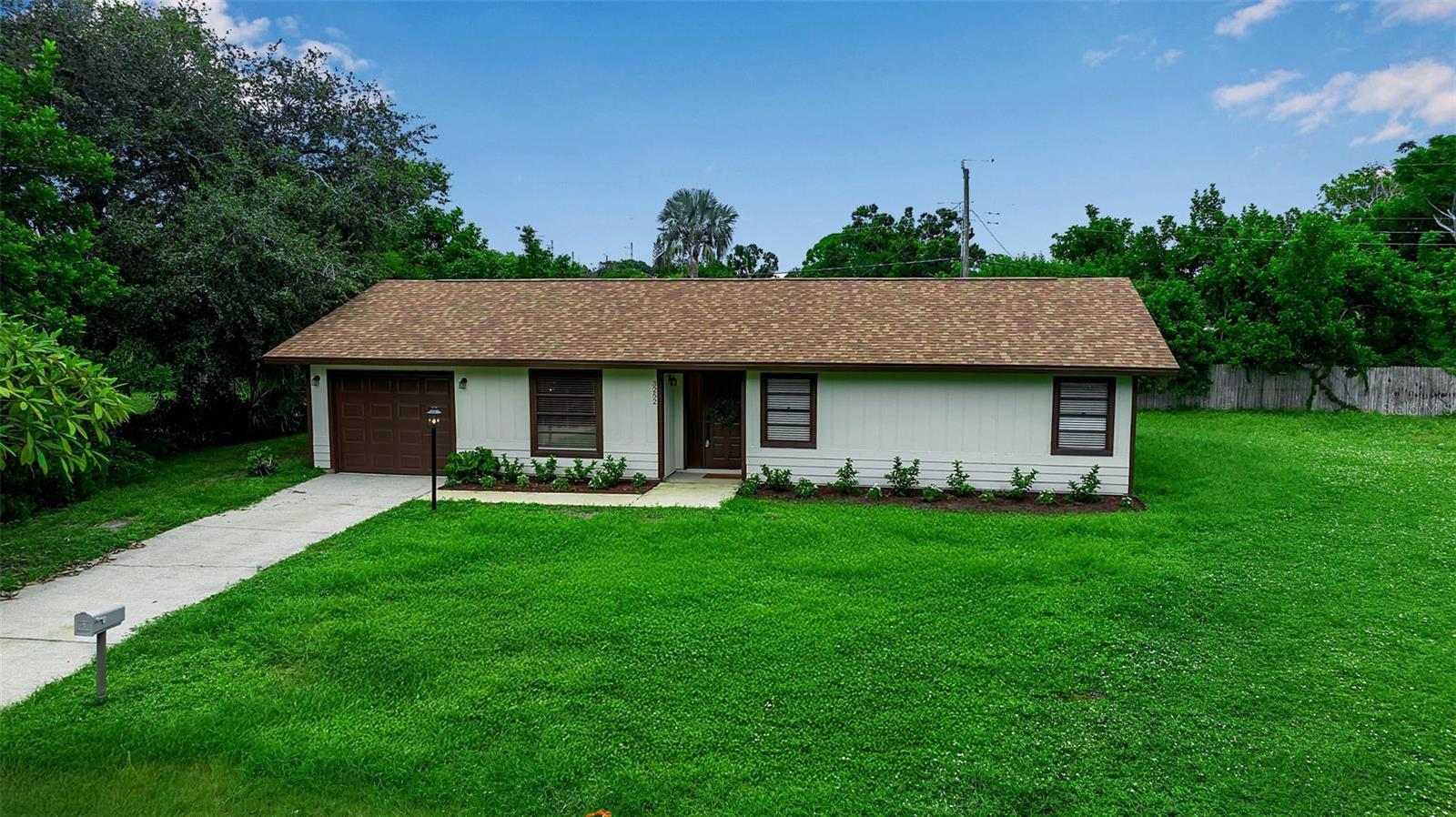 Welcome to 3252 Patton Street – a turn-key, single-story ranch tucked away at the end of a quiet cul-de-sac. in the. This 3-bedroom, 2-bath home sits on a quarter-acre lot with mature landscaping and no HOA.
The interior has been thoughtfully reimagined with a light, modern aesthetic. Wide-plank luxury vinyl floors flow throughout, complemented by fresh white walls and contemporary lighting. At the heart of the home, the chef’s kitchen features soft-close white shaker cabinetry with matte-black hardware, sleek quartz counters with subtle veining, a deep stainless-steel sink with a pull-down faucet and a glass-shade pendant above. Stainless-steel appliances include a smooth-top range, matching hood, fridge, and dishwasher. A roomy pantry closet provides extra storage, while the adjoining dining area opens through sliding glass doors to the screened lanai for effortless indoor-outdoor living.
The open layout continues into a bright living room anchored by a statement black chandelier and a large picture window. Vaulted ceilings enhance the sense of space, and the neutral palette offers a tranquil backdrop for any décor. Off the kitchen is a generous laundry room with a utility sink and access to the one-car garage.
All three bedrooms are generously sized and outfitted with built-in closets. The primary suite enjoys a renovated en-suite bath and direct access to the lanai, creating a private retreat. A second full bath serves the two guest rooms.
Outside, the 0.25-acre property provides a fenced yard with room for a pool, play area or garden. Mature trees offer shade and privacy, while the screened lanai invite you to relax with a morning coffee or evening drink.
From this address you’re about 3.5 miles to downtown Sarasota, 5 miles to Sarasota–Bradenton International Airport and roughly 8 miles to Lido Beach. Public transit stops, grocery stores, restaurants, nightlife, are all within minutes.
With its stylish new interior and central location, 3252 Patton Street offers an exceptional opportunity. Whether you’re a first-time buyer, downsizer or investor, this move-in-ready home delivers modern comfort and Florida charm.