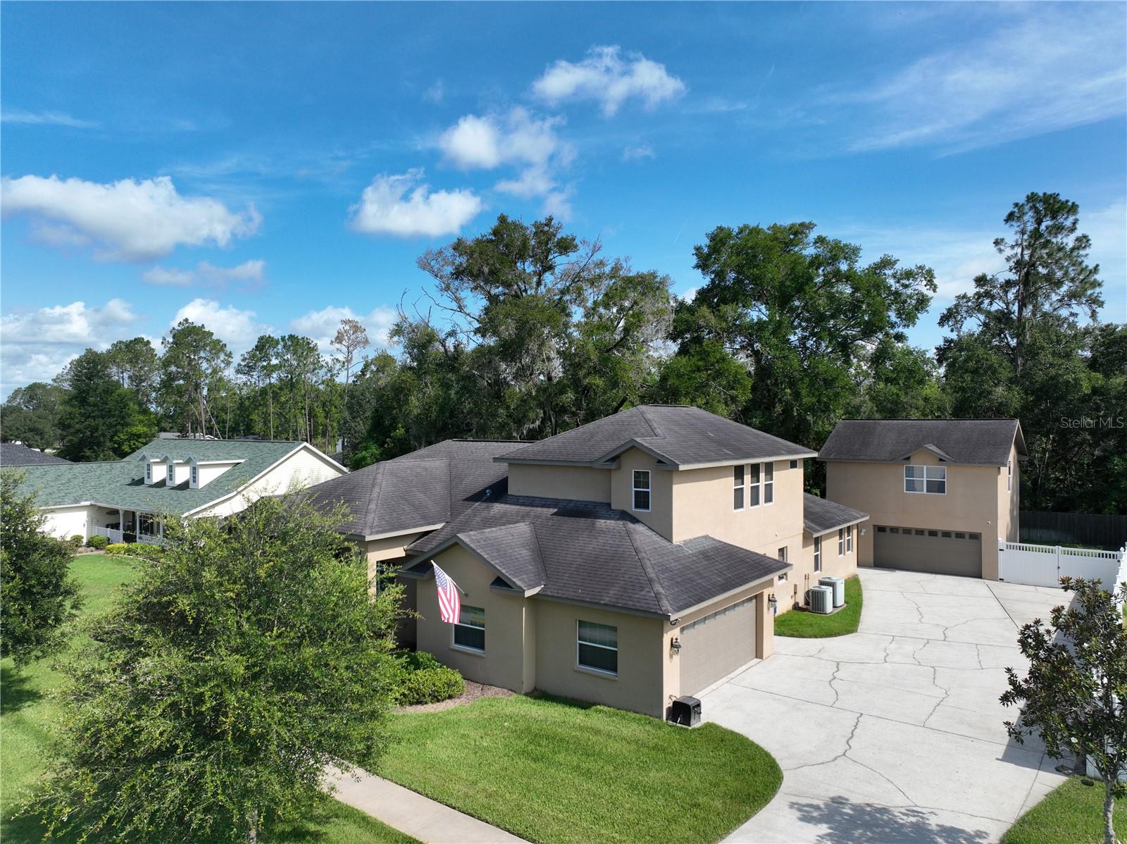 Spacious Custom Home with 5 Bedrooms, 4-Car Garage & Private Backyard Retreat! Seller will replace the roof with an acceptable offer—giving you peace of mind from the start. This custom-designed home offers flexibility, space, and style with 5 bedrooms + bonus rooms, 4 full bathrooms, and a rare 4-car garage setup (2 attached, 2 detached). The main floor features a split-bedroom layout with 4 bedrooms and 3 baths, while upstairs offers a versatile bonus room or secondary master suite with its own private bath. The heart of the home is the spacious kitchen boasting an abundance of cabinetry, modern appliances, and a butler's pantry—perfect for entertaining or everyday living. The primary suite includes a luxurious tiled, no-step walk-in shower, dual vanities, and 2 generous walk-in closets. Panoramic backyard views shine through cascading sliding glass doors that pocket to seamlessly blend indoor and outdoor living. The detached 2-car garage includes a finished second-story bonus room complete with its own bath and mini-split A/C—ideal for guests, a home office, or game room. Pool table and sectional are optional. Step into your private backyard oasis featuring a screened lanai, gazebo, and firepit for year-round enjoyment. Low HOA fees, No CDD—just space, style, and flexibility in a beautifully crafted home.
