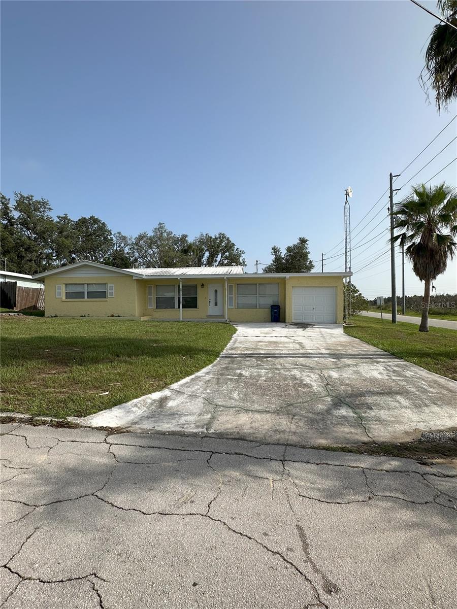 Charming 2-bedroom + extra room/den, 2-bath home on a spacious corner lot in Sebring! This property features a bright, open living area with tile flooring throughout the main living spaces and carpeted bedrooms. The eat-in kitchen offers room for casual dining, while the attached 1-car garage adds everyday convenience. With ample parking, a large yard, and a shed for extra storage, this home provides both comfort and functionality.