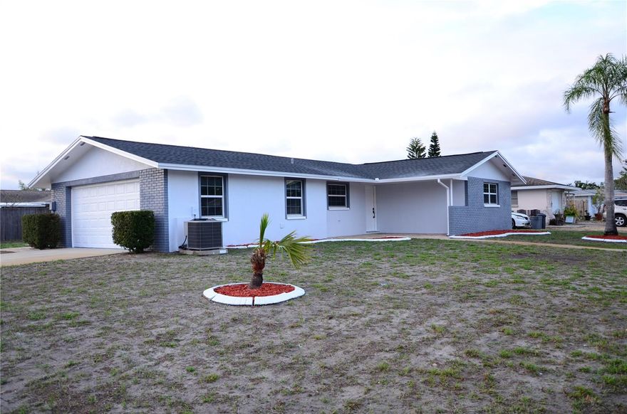 Welcome to this charming 2-bedroom, 2-bathroom, 2-car garage block home, perfectly situated on a large corner lot in the heart of Port Richey. This completely remodeled property offers a comfortable and practical layout ideal for year-round living or seasonal enjoyment. Step inside to find spacious living areas filled with natural light, creating a warm and inviting atmosphere. The kitchen provides plenty of cabinet and counter space, flowing seamlessly into the living room—perfect for entertaining family and friends. Both bedrooms are generously sized, with the primary suite featuring an en-suite bath for added privacy. A screened patio extends the living space outdoors, ideal for enjoying Florida’s beautiful weather. Notable updates include NEW ROOF; Nov 2025, an HVAC system installed in 2017, new garage door couple years ago. The block construction provides peace of mind, and the property’s location outside of a flood zone adds extra confidence and low-cost insurance benefits. Conveniently located near shopping, dining, medical centers, and just a short drive to the Gulf beaches, this home combines comfort, convenience, and value in one great package.