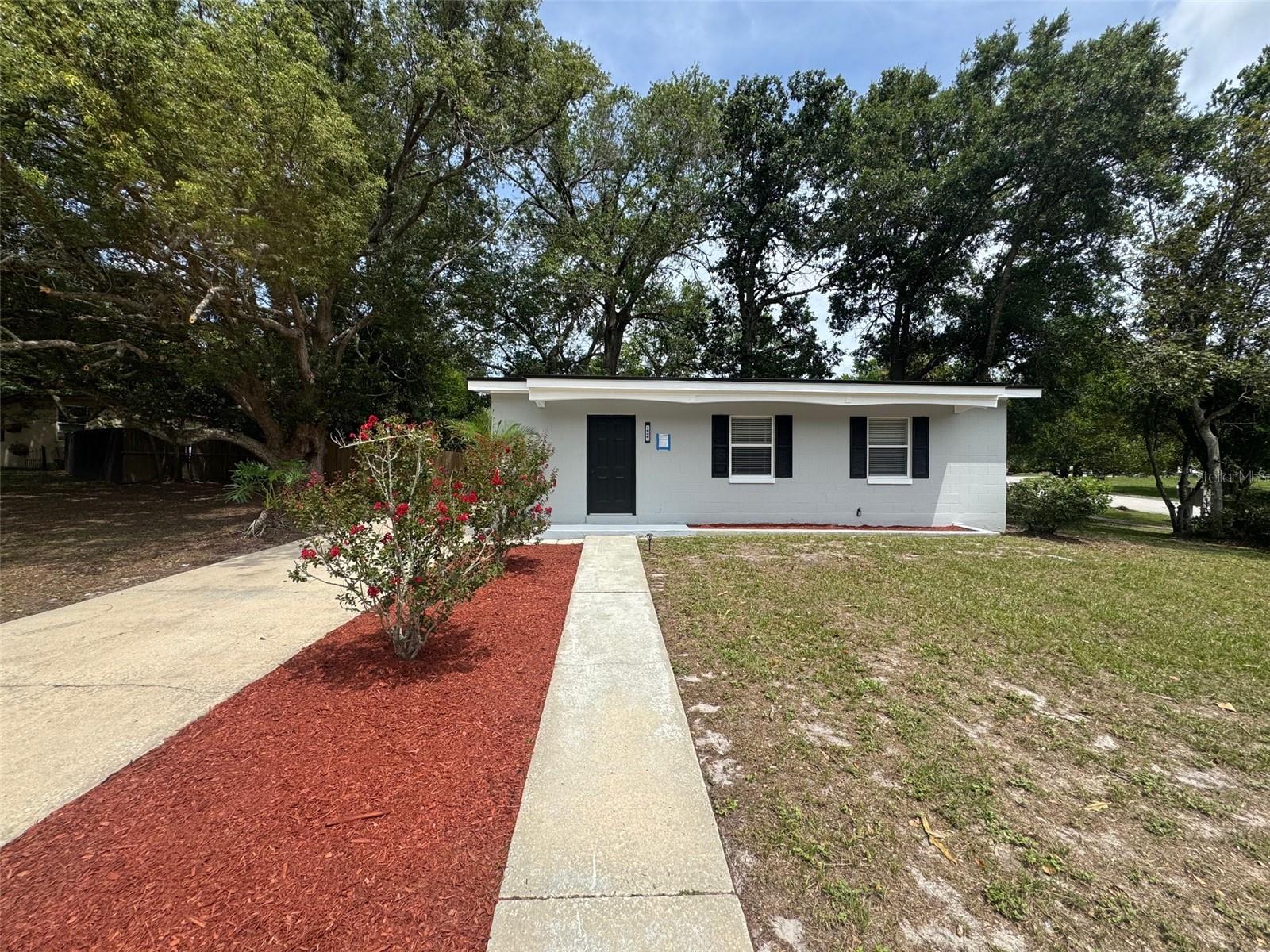 Welcome to your new home. Totally renovated 2 bed, 1 bath , 0.31 acre corner lot block SFH. BRAND NEW ROOF (Jun 25). Kitchen has been remodeled to an open floor concept and now has a huge island , new quartz countertop, cabinets and stainless steel appliances. Bathroom now carries premium porcelain tiles, all of the home's light fixtures, outlets and switches were replaced, new breaker box, new AC wall unit. Natural Gas Water Heater, fully fenced in back yard and nice location close to everything. Located near Publix Shopping Plaza with quick access to I-4, Minutes from grocery stores, restaurants, parks, healthcare, the movie theater, etc. Don't miss out on this opportunity to own a gem in Deltona Lakes! Schedule your showing today!