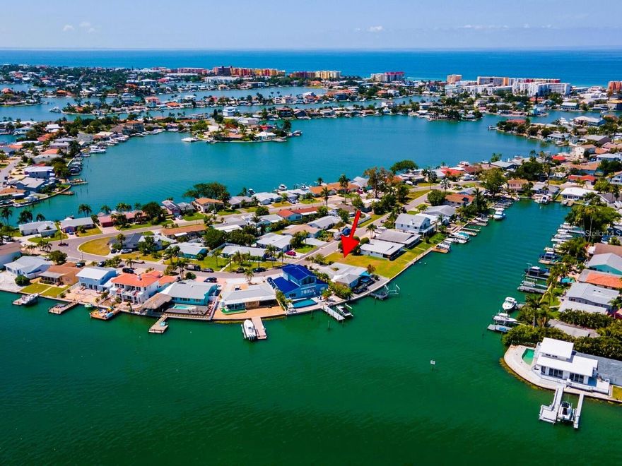 Auction Property. EVERYONE WELCOME TO BID. Come join us for an exciting auction at this stunning waterfront property. Auction sale Held at the Home on December 2, 2023, at 11:00 a.m. Preview starts at 10:00 a.m. Please call us for specific auction terms and conditions. Keep in mind that the property may sell for more or less than the listed price. Everyone is welcome to bid!

Deep Water w/ Direct Gulf Access. Discover the allure of this Redington Shores waterfront gem. This impressive 3-bedroom, 3-bathroom home boasts 1880 sq ft of heated space with a total of 2,248 sqft. It's a dream come true for those seeking the ultimate Florida lifestyle with plenty of space for the family. The moment you step inside, natural light fills every corner, and the open layout ensures you can savor breathtaking water views from almost every angle.

Over the years, this property has been thoughtfully updated: Including newer windows and doors, and a new AC system in 2022. Most all the interior windows are furnished with plantation shutters besides the custom kitchen nook.  In April 2021, an 84-foot brand-new concrete seawall was added, ensuring durability and peace of mind. The roof was installed in 2015. A bonus is the low-maintenance landscaping meaning more time for relaxation and enjoyment.

Boaters dream come true! Deep water, direct gulf access, 13K boat lift (motor is maintained and working well) it also boasts a convenient gangplank making it easy to embark on your next aquatic adventure in just minutes. For waterfront dining options, explore nearby spots like Johns Pass or venture to the Salt Rock Grille. With its prime protected location on the intercoastal, you can navigate south or north for some of the best beaches in the state. 

The master bedroom is a haven, featuring a built-in office nook and French doors that lead to the deck. Motorized window shades and tall ceilings. It's the perfect place to unwind while gazing at the serene water views. The swim spa beckons, offering a place to wash away your cares or swim a few laps. The washer and dryer are located indoors. The bathrooms are all updated including a bathtub, a large walk-in shower, double vanity sinks, and more. 

In addition to all these amenities, it's worth noting that this property boasts the potential for rental rates of over $7,000 per month. Don't miss this extraordinary opportunity to own your own piece of Redington Shores waterfront paradise. Make this home yours and experience the pinnacle of coastal living.