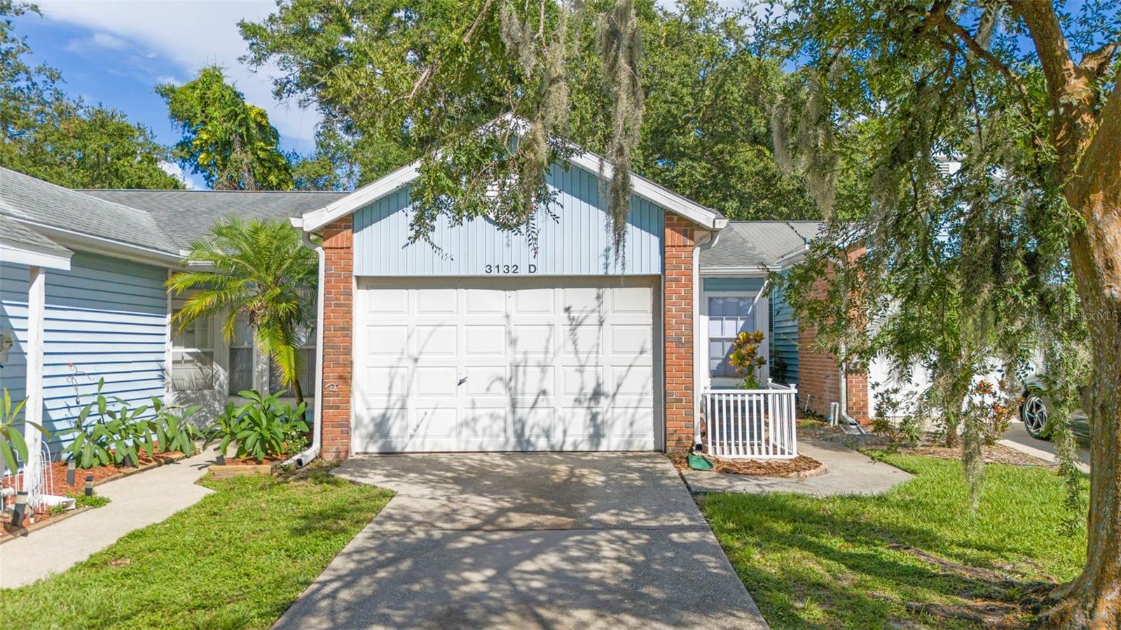 One or more photo(s) has been virtually staged. Welcome home! This affordable villa comes with a oversized 1 Car attached garage and its own private entry. Fresh paint and new luxury vinyl plank floors. The home offers a split 2 bedroom and 2 full bathroom floor plan. The large living room and dining room showcase vaulted ceilings and sliding door access to the screened patio, leading out to the paver-lined backyard. Primary Bedroom has a large walk-in closet, private bath and vanity with sliding doors leading to the screened in patio at the rear of the home. At the front of the home, the first bedroom has French doors and built-in closet. Roof 2019, A/C 2023. Your LOW HOA fee includes use of Community Pool and a Clubhouse, basic cable and internet, water, sewer and trash. No Age restrictions. NO Flood insurance required. Community is walking distance to Sutherland Elementary School--right across the street! Zoned to A rated public schools. Easy access to US 19. Honeymoon Island State Park, the downtowns of Palm Harbor, Dunedin and Tarpon Springs all within less than a 30 minute drive! Set up your showing today!