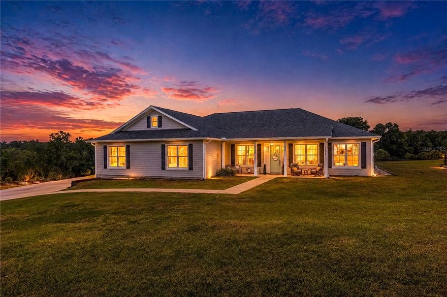 Set on over 7 acres of gently rolling land within the gated Equestrian Springs community, this beautifully built 2022 home blends modern comfort with serene outdoor living. Offering over 2,500 square feet, the thoughtfully designed split-bedroom floor plan includes 4 bedrooms and 2 bathrooms, creating both privacy and functionality. Inside, 10ft high ceilings throughout, crown molding, luxury vinyl flooring, and abundant natural light create an inviting, upscale feel throughout. The open-concept layout centers around a well-appointed kitchen featuring solid wood cabinetry, stainless steel appliances, expansive counter space, a large center island with breakfast bar, a butler’s pantry, and distinctive nickel gap tongue-and-groove wood accents. The kitchen flows seamlessly into the formal dining area and spacious living room, where elegant French doors lead to the back patio which is perfect for indoor-outdoor living and entertaining. The primary suite offers a private retreat with a generous layout, dual walk-in closets, and a spacious en-suite bathroom complete with dual vanities, a garden tub, and a glass-enclosed shower. Additional bedrooms and flexible living spaces provide options for a home office, study, or hobby room. Outdoors is where this property truly stands out. A covered, screen-enclosed patio overlooks the in-ground pool with safety fencing and an expansive pool deck, ideal for enjoying Florida’s year-round sunshine. The A-3 zoning allows for equestrian use, with two existing paddocks featuring board and cross-wire fencing, plus a 20x20 enclosed storage building with open lean-to. Additional highlights include an oversized two-car garage with RV hookups, a fire pit area, and ample space for equipment or recreational vehicles. Equestrian Springs enhances the lifestyle with a private park and a scenic 2-mile, tree-lined bridle path for riding on or off the property. Located within 20 minutes of the World Equestrian Center (WEC), HITS, and Sweet Dixie South, this property offers convenient access to premier equestrian venues. Combining modern construction, flexible land use, and a peaceful setting, this property presents a rare opportunity for both equestrian enthusiasts and those seeking space, privacy, and refined country living.