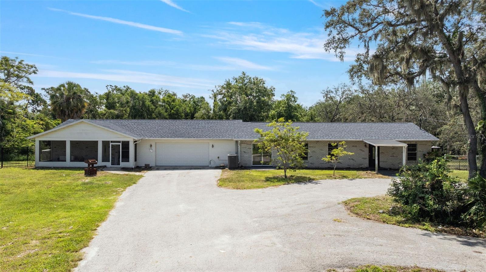 One or more photo(s) has been virtually staged. Discover this private and peaceful ranch-style home set on 2.5 scenic acres, backing up to Bullfrog Creek and surrounded by natural beauty. Listed under appraised value with no HOA or CDD, you’ll enjoy the freedom to truly make this property your own—ideal for those seeking space, privacy, and flexibility. This single-story home features an open layout with brand-new vinyl plank flooring and a new roof installed in 2025, offering a solid foundation for your personal touch. While some cosmetic updates are still needed, the potential is undeniable. One of the home’s standout features is the in-law suite, fully under the same roof but with its own private entrance—perfect for those seeking a multigenerational space, a private guest suite, or rental income opportunities. Equestrian enthusiasts will love the four brand-new horse stalls, with plenty of room for expansion. The private setting, combined with access to the tranquil Bullfrog Creek, makes this a rare country retreat just minutes from town conveniences. Whether you're dreaming of a quiet homestead, a multi-generational property, or an equestrian haven, this home offers space, freedom, and incredible potential—all without the restrictions of an HOA or CDD.