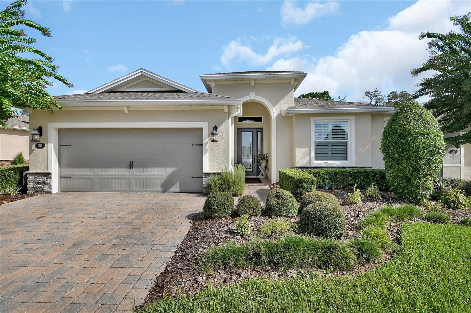DeLand | Meticulously maintained and original owner - this 2018 Kolter "Siena model" home with a private conservation view within the 55+ Cresswind at Victoria Gardens subdivision is move-in ready! This Light & Bright 3 bedroom 3 bathroom plus Den layout offers a 25’ x 16’ screen covered porch that overlooks the natural preserve. Features include ceramic tile flooring as well as engineered wood floors, Double Pane windows, tray ceilings, recessed lighting, Plantation style shutters. Kitchen offers 42” wood cabinets w/ above cabinet lighting, Pull-out shelving, tile backsplash, Quartz countertops, large breakfast island w/ pendant lighting above & stainless steel appliances including a 5-burner natural gas convection cooktop with double oven/ microwave. Built-ins to accommodate cookbooks and window seat in the kitchen and a custom lighted built-in located in the living room . The owner’s suite offers wood flooring and ceramic tile in the bathroom, large walk-in closet with built-in system, tray ceiling, & a conservation view. En-suite bedroom w/ bathroom has a large walk-in shower , quartz vanity. Utility room offers a laundry tub, storage cabinets. You will enjoy relaxing or entertaining on your spacious screen enclosed covered patio with the scenic conservation area view. The 21’ x 21" garage has an epoxy floor finish, fully insulated with mini split A/C and wall to wall cabinets for ample storage. Additional features include: central Vac system and whole house water conditioner. Victoria Garden residents have access to their own Private Clubhouse. Association fee includes: lawn care, cable TV, high speed internet, reclaimed water irrigation and access to all community amenities. Neighborhood is within 1 mile of I-4 that offers great access to the east coast beaches, Orlando (40 minutes), 3 International airports within 1 hour, and Historic Downtown DeLand for shopping and entertainment.