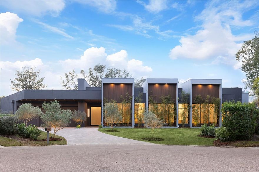 Unparalleled Luxury & International Design in Prestigious Bay Hill, Dr Phillips 
This newly developed, architecturally unique residence in Bay Hill is not merely a house—it is an iconic masterpiece and an internationally inspired designer art piece that redefines the zenith of luxury living in Orlando.

Your grand experience begins by passing through 10-foot modern pivot doors that open like magnificent stage curtains, revealing the home's spectacular scale: Italian hardwood planks grounded below soaring 20-foot ceilings. Sunlight floods the space, bathing a stunning indoor garden oasis with live mini olive trees—a breathtaking, bespoke element that sets an extraordinary tone for the entire estate.

The gourmet kitchen is a true chef’s fantasy, taking center stage with a full suite of Dacor high-end stainless-steel appliances, a sleek oversize waterfall island of impeccable design, and a discreet, built-in Zephyr wine refrigerator. Every curated detail whispers uncompromising sophistication.

Indulge in spa-quality opulence within the bathrooms, featuring exclusive Hansgrohe Axor fixtures and award-winning Duravit toilets. The master sanctuary is a haven of tranquility, complete with a double glass shower and a custom, hand-finished Dado soaking bath designed for ultimate rejuvenation.

Seamless, sophisticated living is achieved through massive sliding doors that effortlessly draw the interior and exterior together. Step out to a breathtaking backyard retreat boasting a dramatic 65-foot shimmering pool, a chic pool deck paved in luxurious Amazon green limestone tiles, and a professional-grade Summerset summer kitchen—perfectly appointed for grand-scale entertaining.

Sited within the ultra-exclusive Bay Hill community, known globally for its championship golf course and the yearly PGA Tournament, this estate places you moments from the world-class dining of Restaurant Row, luxury shopping, and Orlando’s renowned theme parks.

This is more than a property; it is an enduring work of art. An iconic masterpiece awaits. Contact us now to arrange your confidential private showing and experience its allure firsthand.