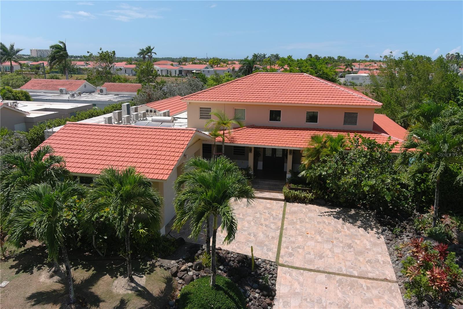 3D VIDEO AVAILABLE! This Casona Carbia “Hacienda Style” home, located on the largest lakefront lot in Sabanera Dorado (16,296 sq. ft.), offers expansive water views, abundant natural light, and an estimated 4,500 sq. ft. of spacious living. The residence features 5 bedrooms, 5.5 bathrooms, and sweeping lake views throughout. A spacious second-floor suite (17'6" x 15'11") includes a private bathroom and a sitting area—ideal for reading or relaxing.
Designed for outdoor enjoyment, the property features an infinity pool, 10-person heated hot tub, and beautifully landscaped gardens. The kitchen includes four refrigerated island cabinets and flows into the family room, perfect for entertaining. The primary suite features a 9' x 17' cedar walk-in closet, double built-in closet, and a serene outdoor soaking tub.
Additional features include a private garage, 22-kilowatt diesel generator, 300-gallon cistern, and water softener. Located near the second gate by Orlando Health Hospital, this home enjoys a prime position within the community.
Sabanera Dorado offers 24/7 security and a wide range of amenities: an Olympic-size pool, clubhouse, fitness center, tennis and basketball courts, soccer field, and scenic trails. The TASIS Dorado School is within the community, and upcoming 2025 enhancements include a state-of-the-art Sports Hub with pickleball courts.
Move into this spacious lakefront residence and renovate it to your taste—an excellent opportunity to create your dream home in one of Puerto Rico’s most desirable communities. Schedule your private tour today.
