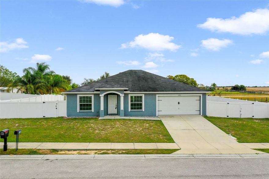 Assumable Mortgage!!! Welcome to this well-maintained 2017 freshly painted four-bed, two-bath home in Davenport, Florida. Inside, the dining room features a pass-through window to the spacious kitchen, equipped with modern stainless appliances, a large sink, ample counter space, cabinetry, and an island/breakfast bar. The master bedroom offers a tray ceiling and walk-in closet, while the master bathroom boasts a dual-sink vanity and garden bathtub. Natural light fills the living room through sliding doors and windows. Additional highlights include a guest bathroom with dual sinks, an inside laundry room, and a vinyl-fenced yard with walk-through and double gates. Centrally located between Orlando and Tampa, with a 30-minute drive to Disney World and Legoland. Don't miss this convenient and charming home—schedule a showing today!