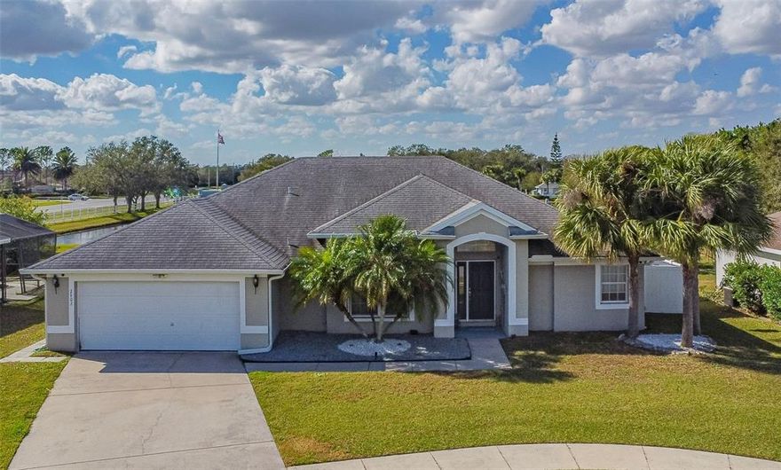 Beautiful home in gated Springlake Village, with breathtaking lake view.  An updated 4 bedroom/2 bath home featuring a spacious open design with vaulted ceiling, great room, dining room, separate dinette area and extended lanai fully screened enclosed. Kitchen overlooks the great room and home has wood grain tile floors throughout with the exception of the master bedroom which offers engineered hardwood. Master bath features dual sinks, garden tub with jets, two walk in closets & a seamless glass shower enclosure. Freshly painted interior walls, 5" baseboards & tall three pane sliding glass door. New A/C installed in 2015. Rear lanai is spacious enough for outdoor parties, with spectacular water view. Oversized back yard to enjoy, two car garage & seamless gutters on the roof. Community amenities include Swimming pool, fitness center, tennis courts, shuffle board, playground & recreation center. Conveniently located near Lake Nona Medical Center, the Orlando International Airport, Austin Tindall Regional Park & easy access to the 417 Expressway.