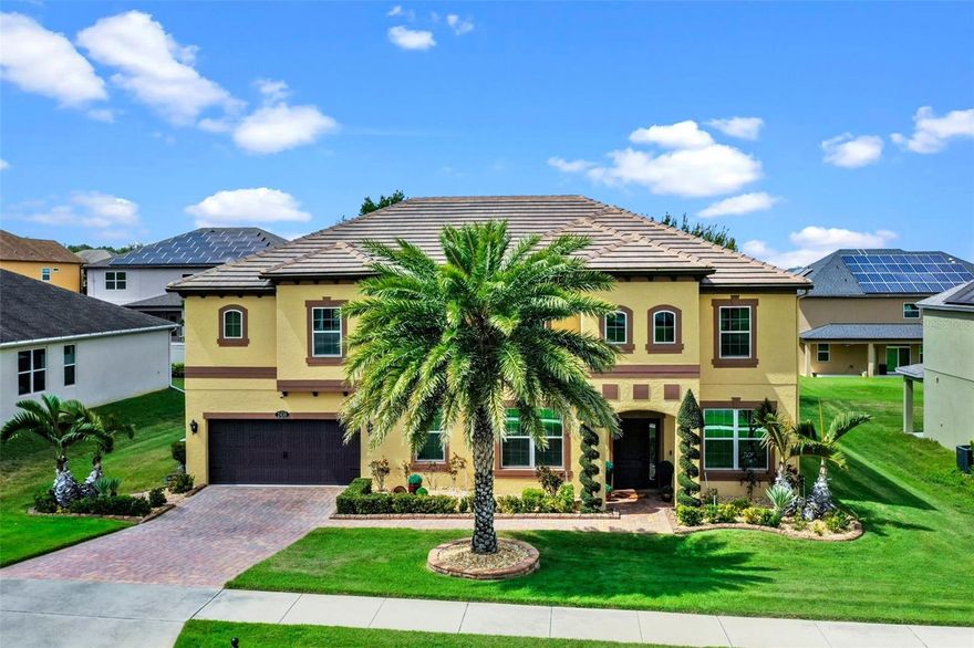 This truly stunning and meticulously cared for five-bedroom, four-bath residence offers over 4,250 square feet of beautifully designed living space, perfect for both family living and entertaining. When you first walk in you can't help but notice the super high ceiling with a massive, stunningly elegant Swarovski crystal chandelier hanging in the entryway. A true showpiece! The dining room to the right also has a Swarovski crystal chandelier for ultimate elegance while you entertain and impress friends and family. The spacious floor plan features a gourmet kitchen with tons of cabinets, a walk-in pantry and granite counters. The kitchen overlooks the family room and the French doors that lead you to the pool area. There is also a generously sized office and dedicated exercise room on the first level as well as a full bath with a door out to the pool area. Heading to the second level you will find a large, light and bright loft for further entertaining and relaxing. The loft also has another large walk-in storage closet with built-in shelving. The luxury vinyl flooring runs through the second floor except for the awesome theater room. No need to go out to the movies for your cinematic experience. The theater room has a huge screen and fantastic picture quality. The sound quality is great as well. Cross through the loft to find the huge primary bedroom suite, also equipped with surround sound. The primary bath has two completely separate vanities, a huge glass walk-in shower and large soaking tub. The closet is fit for royalty. It measures 11-by-12 feet with custom built-ins to fit an abundance of shoes and wardrobe. There are three more extra large bedrooms upstairs all with luxury vinyl flooring and each with walk-in custom closets. The storage in this home is abundant! You will find two more full baths both with tub/shower combos. Walk down the elegant stairway and then outside to your personal resort oasis. A massive screen enclosure keeps you safe from bugs while you relax or swim in the stunning, crystal blue 15-by-30-foot saltwater swimming pool with a heated spa. Your feet will find comfort walking on the exterior all-paver deck. There is a gazebo in the corner for more shade, lounging and privacy. The stone summer kitchen and bar area are outstanding for entertaining friends and family. Beautifully custom-built with a grill, fridge, sink and granite counter bar. An unbelievable spot to catch the game or unwind in style. The exterior is beautifully landscaped and cared for. The home is set in a wonderful small community located so close to shopping, eateries, schools, places of worship and main highways. The fantastic downtown Clermont area where triathlons, races, festivals, and community events are held, is just minutes away. Two new top of the line AC units were just recently installed. This home also has Energy Star spray foam insulation. With its luxurious amenities, modern design, and resort-style features, this home offers the perfect blend of comfort and sophistication.