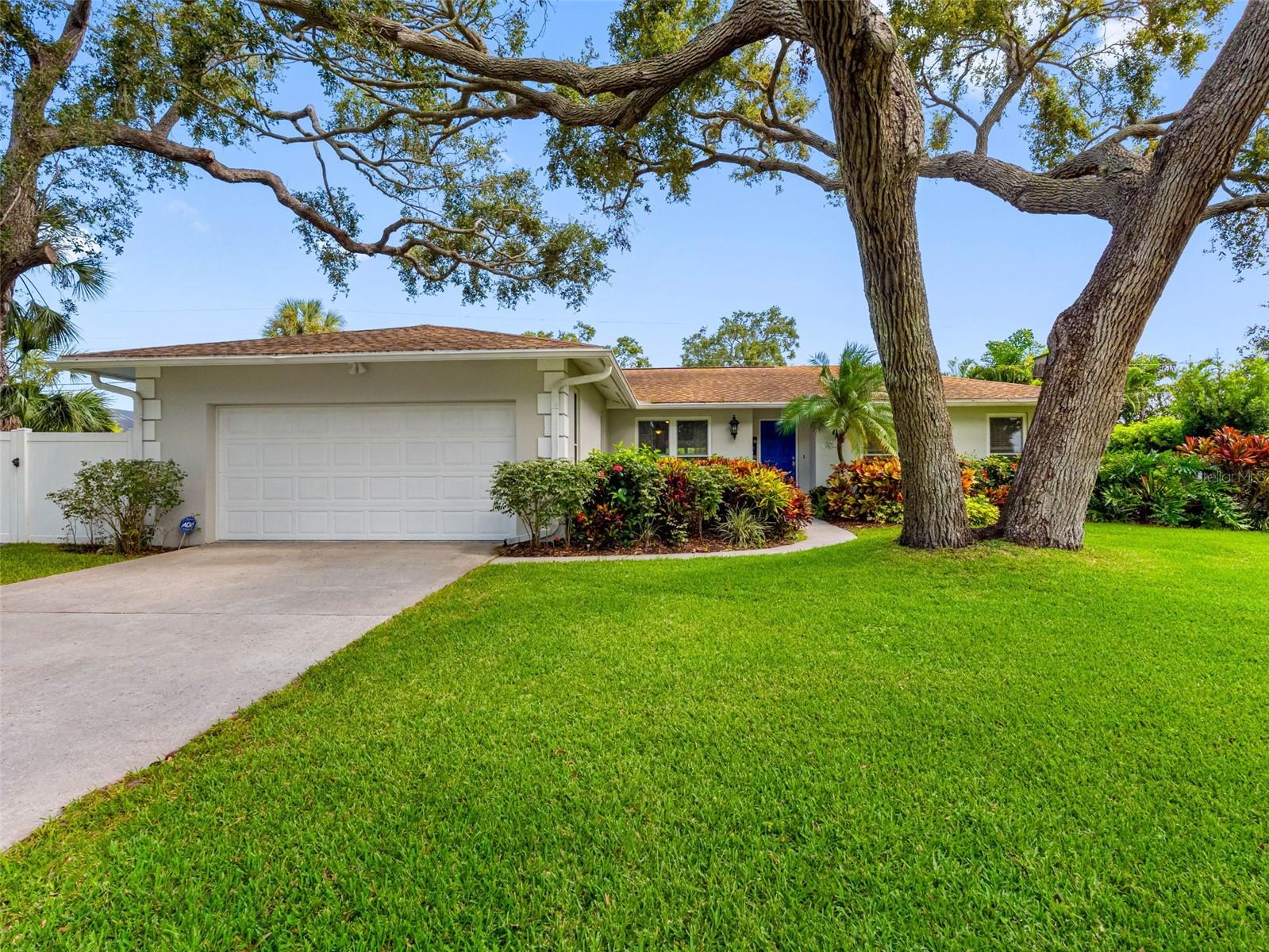 Welcome to Oakdale Manor, a community where mid-century charm meets modern comfort in a peaceful, mature setting. Surrounded by towering live oaks that offer shade and serenity, this neighborhood is ideal for those seeking a relaxed yet connected lifestyle. With easy access to the best of Pinellas County, Oakdale Manor offers both family-friendly appeal and coastal convenience.
The home features an immaculate open-concept layout with a split-bedroom floor plan, offering both spaciousness and privacy. Neutral tile floors flow seamlessly through the living room, dining area, and family room, providing a cohesive, easy-care foundation. An adjoining sunroom overlooks the private backyard and pool. The perfect space to unwind or entertain.
The renovated kitchen is a central highlight, featuring rich wood cabinetry, granite countertops, and a breakfast bar with stylish pendant lighting. A cozy breakfast nook with a bay window overlooks a paved patio, creating a charming space to enjoy your morning coffee or casual meals while taking in the peaceful backyard view.
The private primary suite is set apart from the other bedrooms and includes a walk-in closet and an updated ensuite bathroom with a dual-sink vanity and walk-in shower. Two additional bedrooms, each with ceiling fans, share a renovated hall bathroom that features a tub/shower combo and another dual-sink vanity—ideal for family or guests.
Additional conveniences include a dedicated laundry room with a utility sink and a spacious two-car garage equipped with an automatic door opener. Major system updates provide peace of mind, including a new HVAC system installed in 2023, a roof from 2015 and up-graded impact rated windows provide safety and tranquility. The electrical panel has also been recently upgraded.
Outside, a saltwater pool enhances the backyard’s appeal, creating a private oasis for relaxation and recreation. With its thoughtful updates, inviting layout, and timeless setting, this home in Oakdale Manor is move-in ready and designed for effortless Florida living.