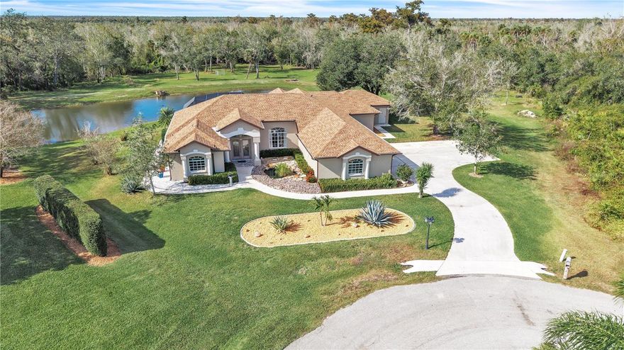 Welcome to this stunning, newly remodeled executive pool home set on over 5 acres in the sought-after, deed-restricted Habitat community.
From the moment you arrive, you’ll notice the peaceful setting with beautiful views of the pond and golf course, along with a charming koi pond and gentle waterfalls at the front entry. Inside, this spacious home offers over 2,600 square feet of living space with 4 bedrooms, 3 bathrooms, and an oversized three-car garage. The open living room draws your eyes straight out to the pool and water views, creating a bright and welcoming feel. A large dining area is perfect for gatherings, while the fully remodeled kitchen (2022) shines with quartz countertops, solid wood cabinets, stainless steel appliances, and abundant storage. The inviting family room features a cozy fireplace and sliders that open to the covered lanai and sparkling pool with waterfall features. The split floor plan includes two generous guest bedrooms and a guest bath, offering privacy for family and visitors. The primary suite is a true retreat with dual walk-in closets, dual vanities, a soaking tub, and a Roman shower. All bathrooms were fully updated in 2022, adding a fresh, modern feel throughout the home. Outside, enjoy a freshly painted exterior, mature landscaping, underground utilities, extra guest parking, and a covered pool area with space for grilling and dining. Recent improvements include a new roof in 2024, septic system in 2022, and a resurfaced pool, new pool cage, and new pool deck in 2024. Located just 15 minutes from Punta Gorda Airport and close to golf, dining, and everyday conveniences, this home offers the perfect blend of privacy, comfort, and location. Schedule your own personal tour today!