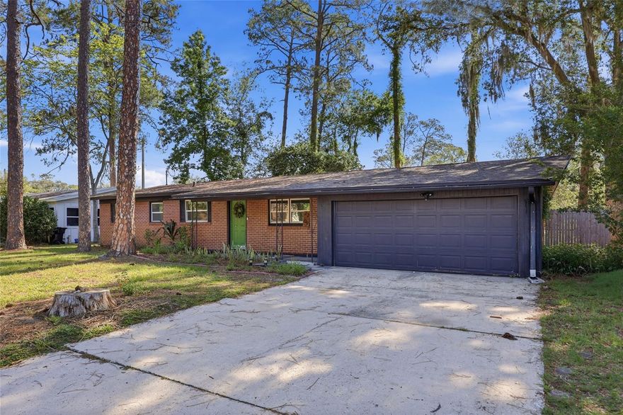 Welcome home to this updated 4-bedroom, 2-bath brick home located in established Carol Estates in NE Gainesville. This move-in ready property features a thoughtfully updated kitchen with modern finishes, updated cabinetry, stylish countertops, and newer appliances, creating the perfect space for everyday living and entertaining. Both bathrooms have also been renovated with updated fixtures and finishes for a fresh, modern feel. Inside, you’ll love the durable wood-look tile flooring that flows throughout the main living areas, offering both style and easy maintenance. The spacious floor plan provides flexibility and privacy with 4 bedrooms plus an office nook off the dining area. Additional highlights include a desirable 2-car garage with plenty of room for parking, storage, hobbies, or a workshop space, plus a large fenced lot with room to enjoy the outdoors. No worries on system ages as HVAC was replaced in 2021, Roof 2018 and Water Heater 2021. Conveniently located near downtown Gainesville, the University of Florida, shopping, restaurants, and parks, this home offers the perfect combination of comfort, updates, and location all with no HOA!