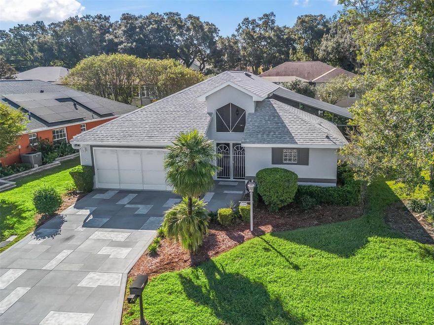 One or more photo(s) has been virtually staged. Stonecrest is a 55+ gated golf course community with all the amenities and 4 pools (one indoor),  and just a Bridge Away By Golf Cart To The Villages! Exceptional 3/2.5 Concrete Block & Stucco Sawgrass Casita Villa with an Oversized 2 Car Garage, and Plenty of Privacy, for both the Owner's and their Guests!  The Villa's landscaping, mulching, and outside pest control is maintained by the POA ($248.00 monthly).  This Sawgrass Casita Villa offers tremendous curb appeal featuring Low Maintenance Professional Landscaping, Painted Concrete Driveway & Walkway, and Double Entry Screen Doors to the Private Birdcage Enclosed Courtyard abundant with Lush Florida Tropical Foliage, Dwarf Palms, Iris, Angel Trumpets, Gardenias, Ferns, Jasmine, Birds of Paradise, and a Serene Rock Garden with Waterfall creating an amazing Private Oasis!  This Unique home offers a Fantastic Floor Plan featuring the 3rd Bedroom as the DETACHED CASITA with a Private Entrance, Kitchenette, Closets, Full Bathroom, Television, and a Built-In Murphy Bed!  No Carpet! Luxury Vinyl Plank flooring  (Waterproof & Fire-Resistant), an Open Concept Floor plan, Vaulted ceilings, Whole house Water Filtration & Softening system (warranty), New Double pane Energy efficient windows & Sliding glass doors, 80 gallon SOLAR Hot Water Heater (warranty), and LED Lighting throughout!  The main house showcases a Stunning Kitchen with Reverse Osmosis Pure Water Drinking system, Granite countertops, LG Smart Stainless Double Oven, Stainless LG appliances (warranty), Built in Desk, Generous Breakfast Bar with additional storage, Wood cabinetry with under & over cabinet lighting, and 2 Pantry closets.  The Spacious Living & Family areas boast an Alexa Integrated Voice Command Lighted Fans, Alexa-controlled Thermostat, Schlage Front Door Lock, Ring Doorbell with Driveway Camera, Tile Television wall with top of the line Electric Fireplace, New 77" HD 4k Smart TV (warranty), and Vaulted ceilings with additional LED lights!  The Luxurious Primary Suite provides Private Entry to the Courtyard, a Large Walk in Closet with Custom Built-Ins, and a Newly Remodeled En Suite Bathroom, featuring a 2 Sink Vanity, Kohler Step-in Tub, and and Expanded Walk in Shower with Rain showerhead, and Body Jets!  Bedroom Two features a Nice size built-in closet, Built-In Cabinetry, and Smart TV!  Enjoy the convenience of the Inside Laundry room with LG Washtower (warranty)!   You will love having plenty of room for storage in the Oversized 2 Car Garage with Insulated Garage Door, Rebuilt Garage Mechanism & Track (9 years on warranty), Work bench, Additional Shelving, Additional Lighting, and SOLAR Attic fan!  ROOF 2018, Stonecrest is a 55+ gated golf course community with all the amenities, pools, pickleball courts, softball, 18 hole championship golf course, 2 Fishing Lakes, 2 Dog Parks, Broad Stripes Golf & Social Club and over 90 different clubs to join in the 12,000 sq ft Community Center and separate Crest Club hosting a staffed Computer room with Free classes, arts and crafts and card/gaming areas, a billiards room, a library and a 1200+ video lending library! As a private gated golf course community, you can expect a high level of privacy and security. This Exceptional Sawgrass Casita Villa offers a combination of Tremendous Outdoor Space, Unique Floor Plan, Luxurious Features, a Fantastic Location, and a Secure Community Setting. A WONDERFUL LIFESTYLE AWAITS YOU IN STONECREST!