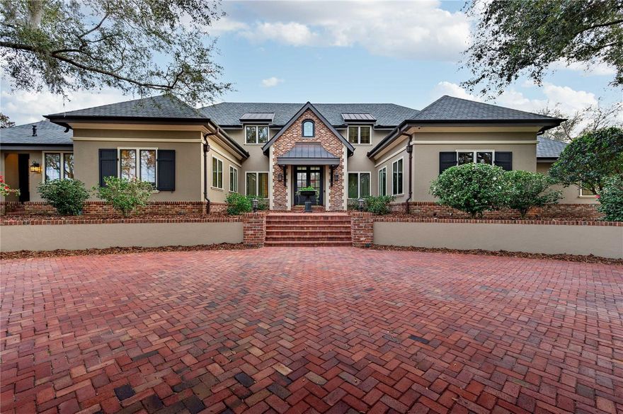 Discover the timeless elegance of this French country style home nestled on 3.6 acres of picturesque land in the exclusive “Estates” section of beautiful Lake Jovita Golf and Country Club. Arrive in style at this exquisite residence, where a grand first impression awaits with the meticulously crafted circular driveway setting the tone of luxury. As you pull up, a captivating water fountain greets you, creating a serene and elegant ambiance.  The Main house boasts five bedrooms, six and one half bathrooms, and over 8700 sq. ft. of conditioned living space that gives this residence a perfect blend of luxury and comfort. The elegant foyer leads you to the kitchen, a chef's dream, with windows overlooking Finger Bowl Lake and adorned with beautiful granite countertops, dual sinks, custom wood cabinets, Viking Professional appliances and walk-in wine cellar. Just off the kitchen is the butler’s pantry with dishwasher, Viking oven and refrigerator/freezer. Step into the epitome of spacious elegance in the family room with grand 20-foot high cathedral ceilings adorned with exposed beams. The room exudes warmth and charm with a large fireplace, creating a focal point that invites gatherings and cozy moments. Adding to the allure, balconies from the second floor provide a captivating vantage point, allowing family members and guests to overlook the inviting expanse below. With a perfect blend of architectural magnificence and comfort, this family room is a sanctuary where cherished memories are created.
The master suite greets you with a coffered ceiling and custom mill work, wet bar, and French doors leading out to a private patio. Separate his and hers en suite bathrooms compliment the East wing. Hers features custom cabinetry, soaker tub, and custom walk-in closet. His features custom cabinetry, walk-in closet, walk-in steam shower, and a private dressing room. Just off the master suite is your private office with built-ins, custom milled tray ceiling, and French doors leading out to the gardens. Ane expansive sunroom seamlessly joins indoor and outdoor living and serves as a gateway to the backyard oasis, inviting nature inside with its vast windows and open design. As the backyard slopes, it unveils an entertainer’s dream with its multi-tiered paradise, offering numerous entertainment zones. A picturesque landscape unfolds, leading you to a luxurious saltwater pool and spa, the focal points of relaxation and recreation. The pool house, a masterpiece of design, stands as a testament to opulence and functionality. This haven of luxury, is equipped with amenities such as: gym/sixth bedroom, stone walls, wood floors, 8 seat bar, large stainless grill with vent hood, dishwasher, warming and refrigerator/freezer drawers, microwave convection oven, air conditioning, misting system, cathedral ceilings with custom mill work, full bathroom with walk-in shower, dining area, and fully automated screens that open to the pool deck.
The newly constructed oversized four car garage provides ample space for your cars and toys. New architectural shingle roofs installed in 2021 and adorned with copper gutters, and new windows and doors in 2022.  The entire home is controlled by a Crestron central electronic system with user friendly interfaces throughout the home and includes a Generac whole house generator.  Sale includes separate buildable lot adjacent to main house. Call today to schedule your private tour to fully appreciate all this home has to offer. Bedroom Closet Type: Walk-in Closet (Primary Bedroom).