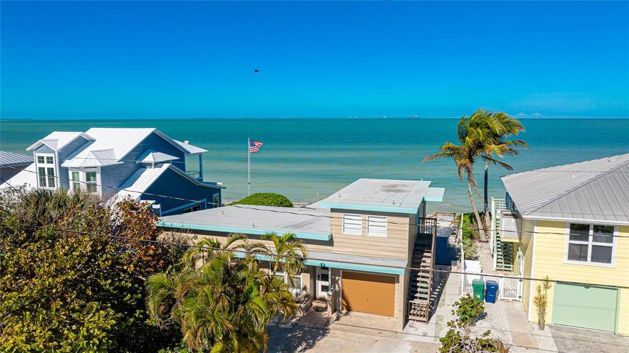 Enjoy spectacular water views from almost every room of this unique 3/3 home. Located directly on Tampa Bay , this rare property has a specially restricted beach that only allows the general public to walk by, but prohibits sitting there, assuring your peace and privacy. Built in the charming old Florida architectural style, this home features a unique pre-existing non conforming guest suite over the one car garage with a separate entrance. In the suite, your guests will enjoy a bedroom, kitchen, and a full bath as well as a private balcony with a one of a kind view of the Bay. But your guests aren't the only lucky ones! You have a large outdoor entertaining area with the same Bay view. This "forever view" is only available to 49 lots and this is one of them. Combine this with a remodeled kitchen and bathrooms, a living/dining combination, and two comfy bedrooms with sunshine pouring into evey room! Walk to the shops and restaurants along Pine Avenue, Rod & Reel Pier, City Pier or Galati's Marina...or just go fishing or kayaking fron your beach. One of the favorite things the owners enjoy is gazing at the stars at night with the Sunshine Skyway off in the distance. This is a rare opportunity to purchase this jewel of a property.