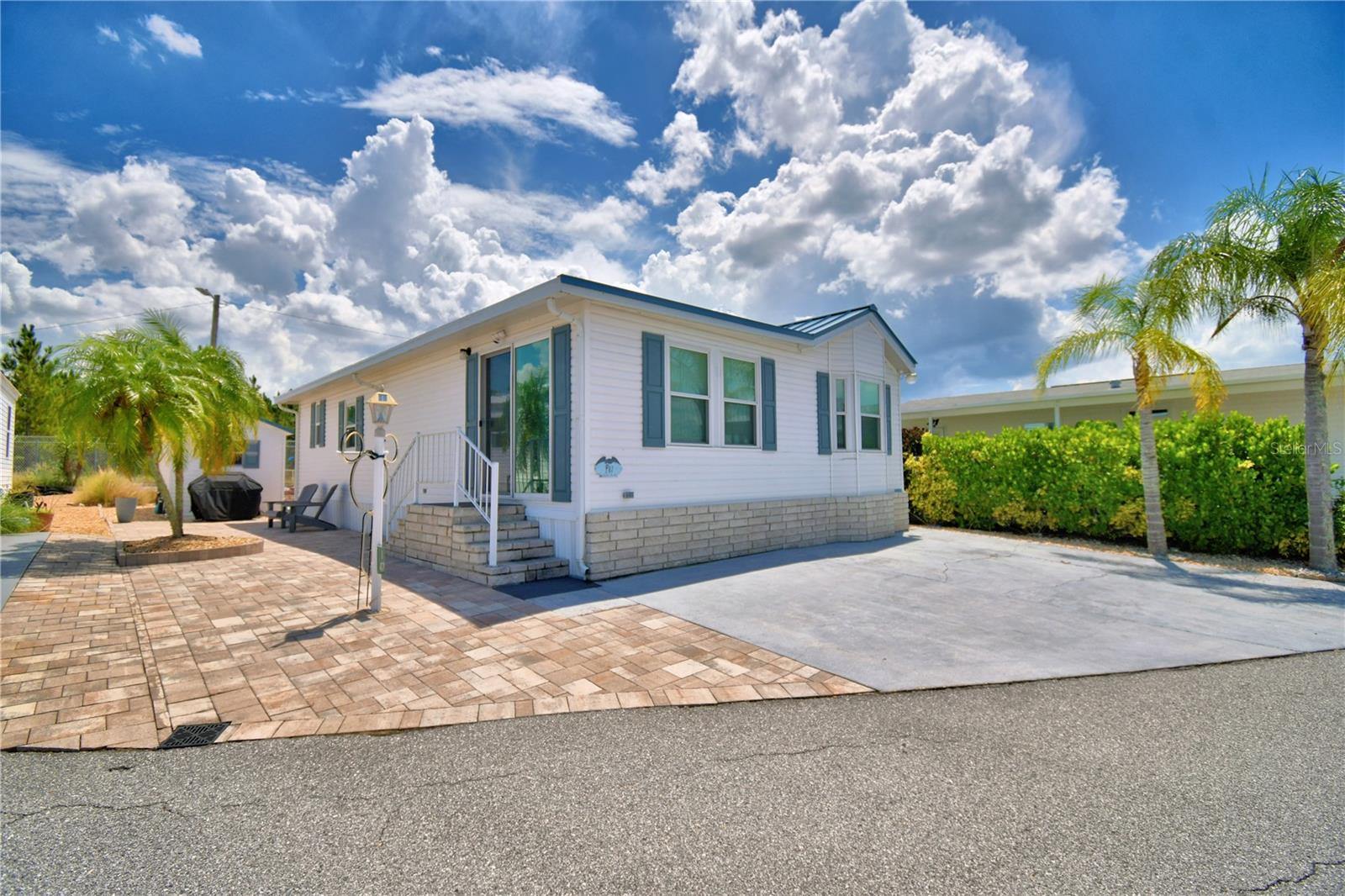 BEAUTIFUL FLORIDA HOME offering 1040 sq ft of SERENITY as soon as you walk through the door!! Located in a well-maintained 55+ community in the heart of CENTRAL FLORIDA where you OWN YOUR LAND. This 2010 Homes of Merit built home with so many upgrades done (HVAC 6yrs old and all WINDOWS/DOOR installed March 2021) along with Plantation Shutters on all the windows which helps with the monthly electric bill. Home is a 2B/2B with an OPEN FLOOR PLAN, large kitchen with GRANITE countertops and STAINLESS appliances. Separate dining room with lots of cabinets and built in desk area. Master Bath offers a walk-in shower with a very calming color scheme. Guest Bath has tub/shower. Inside laundry closet with washer/dryer and back door to access your Brick Paver private backyard area with outdoor furniture and 8x10 SHED for storage. GATED COMMUNITY with front and back entrances/exits. HEATED POOL and Recreation Hall with various amenities, Pickleball Court, Bocce Ball and so much more. Located near restaurants, medical, shopping and major roadways that lead to Florida Attractions, Airports and East/West Coast Beaches! Come join the 55+ LIFESTYLE of WEST VIEW RIDGE. Call Susie for your private showing. SEE VIRTUAL TOUR.