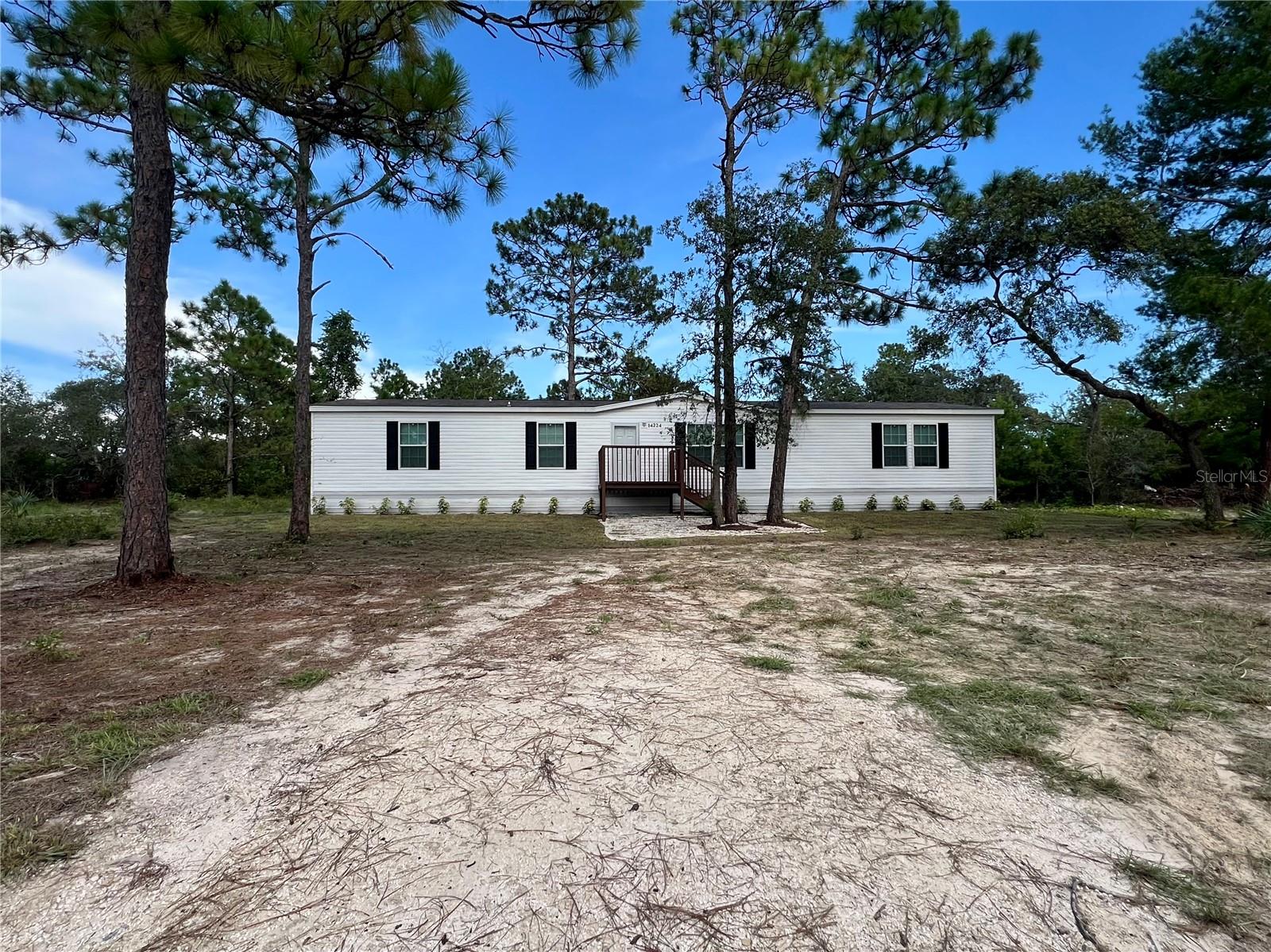 This 2025 manufactured home in Brooksville offers 5 bedrooms, 3 full bathrooms, and 2,027 square feet of comfortable living space, all nestled on 2.5 acres of flat, usable land. Step inside to discover a split floor plan that provides privacy and flexibility, ideal for multi-generational living, home offices, or guest accommodations. The open layout flows easily from room to room, making it perfect for relaxing or entertaining. Outside, enjoy the wide-open space—ideal for gardening, outdoor hobbies, and play. With no HOA and no CDD, you have the freedom to truly make this property your own. You'll love the peaceful, country atmosphere while staying conveniently close to Brooksville’s shops, restaurants, and essential services. It's the best of both worlds—quiet surroundings with easy access to everything you need.
