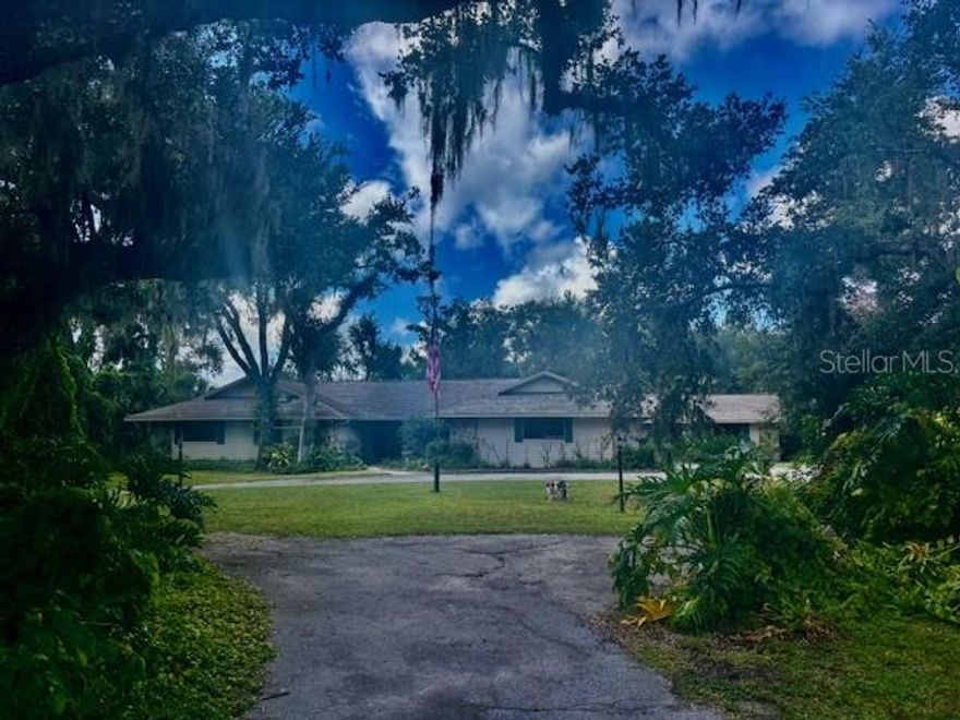 Step into a slice of Southern elegance with this breathtaking property in Myakka Valley Ranches - easily the most beautiful property in this equestrian neighborhood.  Think "Gone with the Wind" charm blended with the real, natural Florida.  
Myakka Valley Ranches is a beautiful equestrian community with miles of horse and walking trails.  Even if you don't own horses, the trails are beautiful and serene for walking and running.
Literally adjacent to the largest State park in Florida (Myakka River State Park) and only 25 minutes from the world famous Siesta Key Beach, this home offers the Best of Florida's Nature and Coast.
This four bedroom three and a half bath estate spans 6,200 sq. ft. under roof, with 3,805 of air conditioned luxury, all set in a serene park-like environment.  
The large in-ground swimming pool is screened in and UNDER ROOF, giving it the feeling of an idooor oasis while actually being an outdoor retreat.
The lanai overlooks a gorgeous pond stocked with fish and complete with a dock.  
Inside you will find a stunning wood burning fireplace , a spacious game room/office, and an open kitchen that flows seamlessly into the great room and pool area.
In addition to the attached oversized 2 car garage, additional features include a three bay outbuilding garage and a second large outbuilding storage facility, providing ample space for vehicles, equipment , or hobbies.
With three separate AC zones, this home is as comfortable as it is flexible in providing numerous privacy options.
Don't miss this opportunity to own this unique slice of paradise!