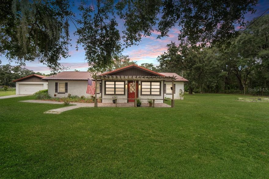 One or more photo(s) has been virtually staged. Wide open space with .79 acres this is an Escape to the serene embrace of countryside living! Fishhawk Middle/High Schools (Barrington and Newsome) and Dawson Elementary School. This is the best of both worlds - you can have the country charm and still be near shopping, highways and top rated schools!  Nestled within the picturesque landscape, this welcoming home offers a cozy and inviting ambiance that captures the essence of rural living. Front porch with a pergola is a great spot for chairs to soak in the Florida sun.  Step inside to discover large living areas!  You are greeted by the Sunroom when you walk in - a great living space with multiple ceiling fans.  Living room with brick fireplace and built in shelves creates a space to unwind and entertain.  This Kitchen will delight with stainless steel appliances, granite countertops, a window to the bonus room and brick accent wall.  A formal dining room just off the kitchen, be sure to look up to take in the rustic charm of the reclaimed wood ceiling, setting the stage for memorable gatherings. Bonus Room is the setting to a third living space and lets you get creative with the space you need.  Large windows and closets for extra storage in this room too - could be a work space, movie room or hobby activity room.  Your master suite offers a private sanctuary with a generously sized walk-in closet and a serene bathroom. Screened Lanai off the dining room. Detached two car garage with covered patio. With a vast fenced yard and no HOA fees and no deed restrictions, your imagination can run wild as you tailor the outdoor space to your dreams. This idyllic location offers a harmonious blend of countryside tranquility and accessibility to schools, parks, and entertainment options. Your perfect country retreat awaits, meticulously designed for your comfort and enjoyment. Seize the opportunity to make this exceptional property your own!