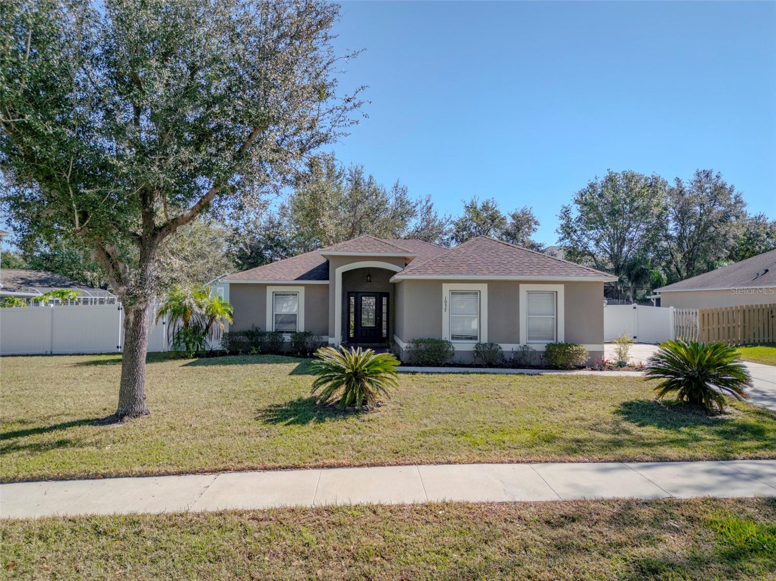 This classic Florida style home has a side entry garage and huge fenced yard! Roof and Water Purification is 3 years old and New Paint inside the house. Double gates allow you to utilize the space for boat storage and your future pool! The back lanai is screened and an additional paver deck with raised plant beds are the perfect backdrop for BBQ'S and a fire pit! Inside the home has a great floor plan with 3 bedrooms, formal dining and a great room adjoining the kitchen. The cathedral ceilings and nice window placement makes the home feel even larger with great natural light! The kitchen has a breakfast nook, 42" raised panel cabinets are a rich dark walnut and beautiful complimentary granite countertops. All stainless appliances convey! The primary bath has dual sinks and a nice walk in shower! The home has lovely light fixtures and just needs a little update to the paint scheme! Located just minutes from the high school, shopping and restaurants! Just a few miles outside of Clermont!