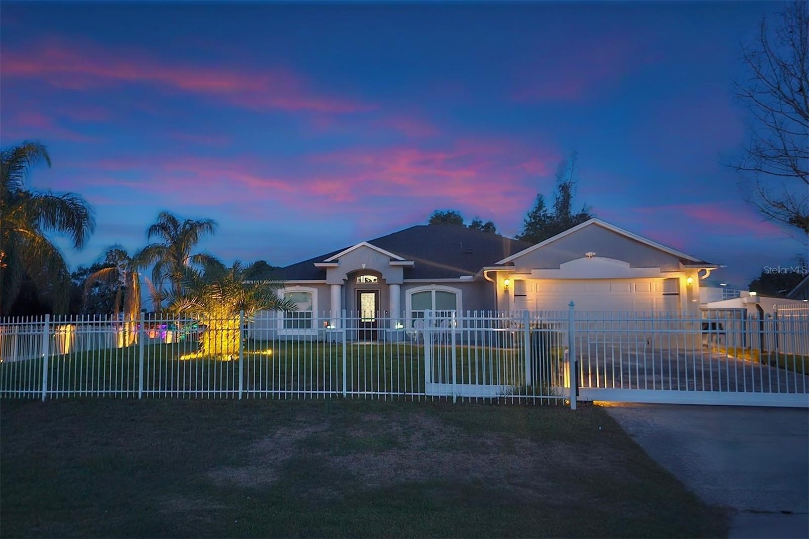 Welcome to this beautifully renovated Florida retreat, perfectly positioned on a corner lot in a sought-after Deltona neighborhood — with NO HOA! This 4-bedroom, 2-bath pool home combines style, comfort, and smart-home technology for modern living. Arrive through the gated drive, enhanced by a top-tier security system, and step inside to find a fully updated interior featuring porcelain tile throughout, plantation shutters, recessed lighting, and an upgraded kitchen. The split floor plan offers a formal dining room and a versatile flex space that easily functions as a home office or additional lounge area. The oversized primary suite provides ample room for a sitting area, full bedroom set, and a custom walk-in closet with built-in shelving. The ensuite bath includes dual sinks, a walk-in shower, and a soaking tub. The gourmet kitchen is filled with natural light and designed for the chef at heart, boasting 42” cabinetry, a quartz island with storage, a breakfast bar, granite countertops, and premium GE appliances — including a smart refrigerator and convection oven with air-fryer capability. With its 10-foot breakfast bar and open-concept layout, the space is ideal for entertaining. French doors lead to the screened saltwater pool and spa, resurfaced just 2 years ago. Complete with solar heating, a waterfall feature, smart lighting, and an expansive paver patio with dining and seating areas, this backyard oasis is perfect for year-round enjoyment. The fully fenced yard also features a solar-powered remote gate for added privacy and security. Technology and safety upgrades include a Ring doorbell, Nest floodlight camera, and an 8-camera NIGHTOWL system with kitchen monitor. Additional improvements: impact windows and doors (2022, lifetime transferable warranty), new roof (2018), Daikin 20 SEER HVAC (2023, transferable warranty), irrigation system (2021), and updated screen enclosure (2021). Other highlights include an inside laundry room with cabinetry, new pocket lighting, generous storage and linen space, and proximity to local parks, splash pad, basketball courts, and running trails. Don’t miss this turn-key pool home loaded with upgrades and modern touches — schedule your private showing today! **One or more of these photos have been virtually edited. Home is Seller occupied.**
