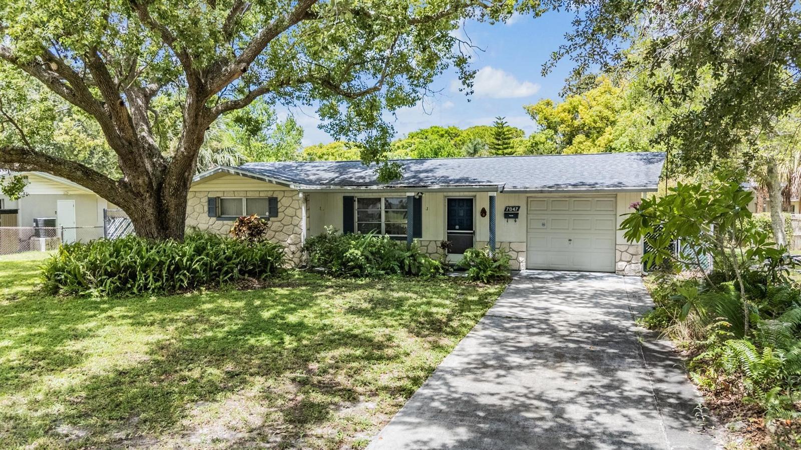 Charming 2-bedroom, 2-bath, 1-car garage home in the heart of New Port Richey! This single-story home offers peace of mind with the big-ticket items already done?new roof in 2018, updated AC in 2019, and a Square D electric panel. Inside, the home is ready for your personal touch and updates to make it your own. Seller has lived here over 30 years and home has never flooded.
Enjoy outdoor living on the screened rear porch overlooking the HUGE fenced backyard, perfect for pets, entertaining, or future expansions. The yard features a vinyl-sided shed/workshop with electric and even a large dog house for pet lovers.
Whether you're a first-time buyer or looking to downsize into a comfortable retirement home, this property offers endless potential with all the essentials already in place. Conveniently located near shopping, dining, and beaches.